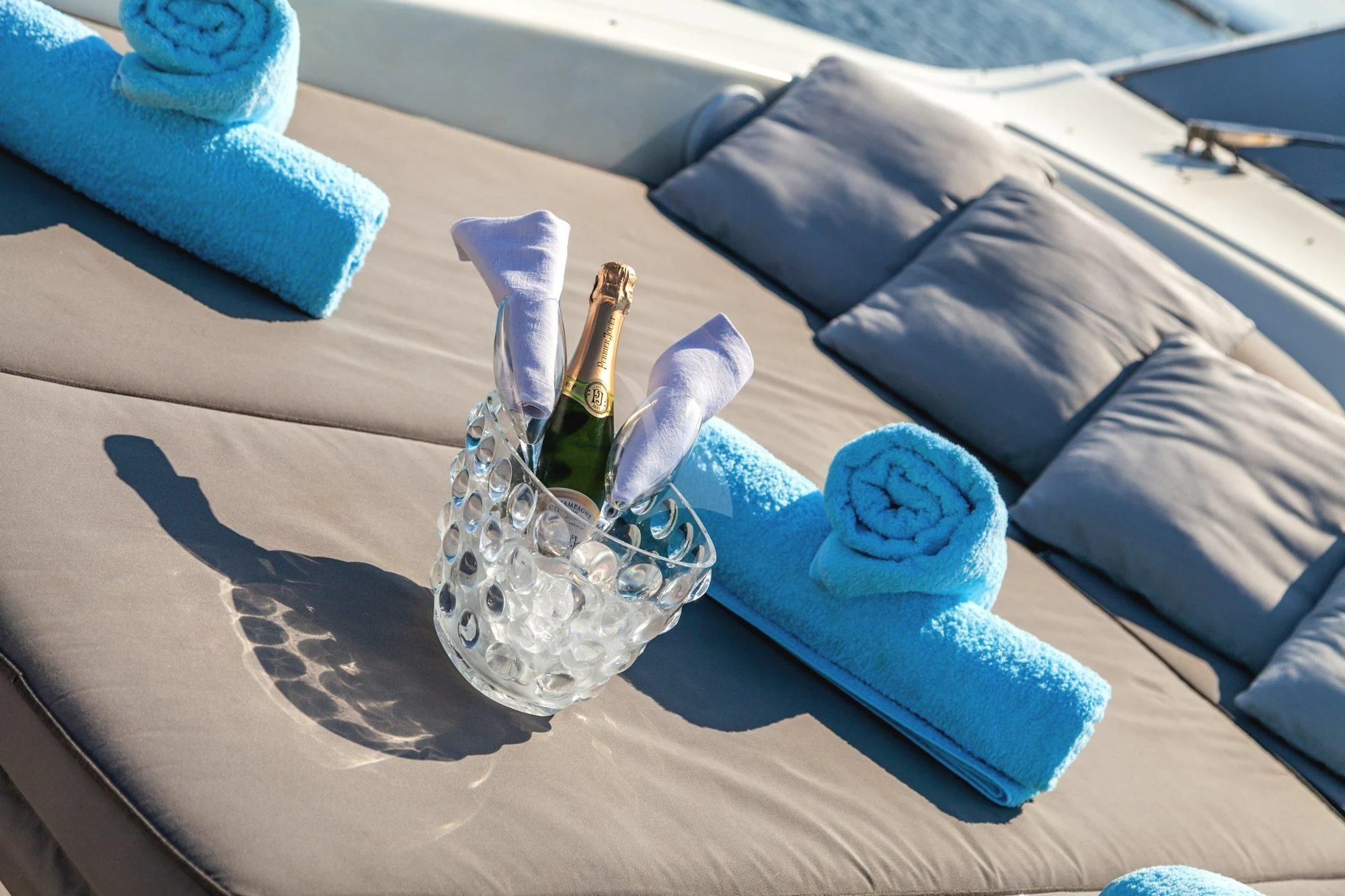 a bottle of champagne and a glass on a table aboard MINOU Yacht for Sale