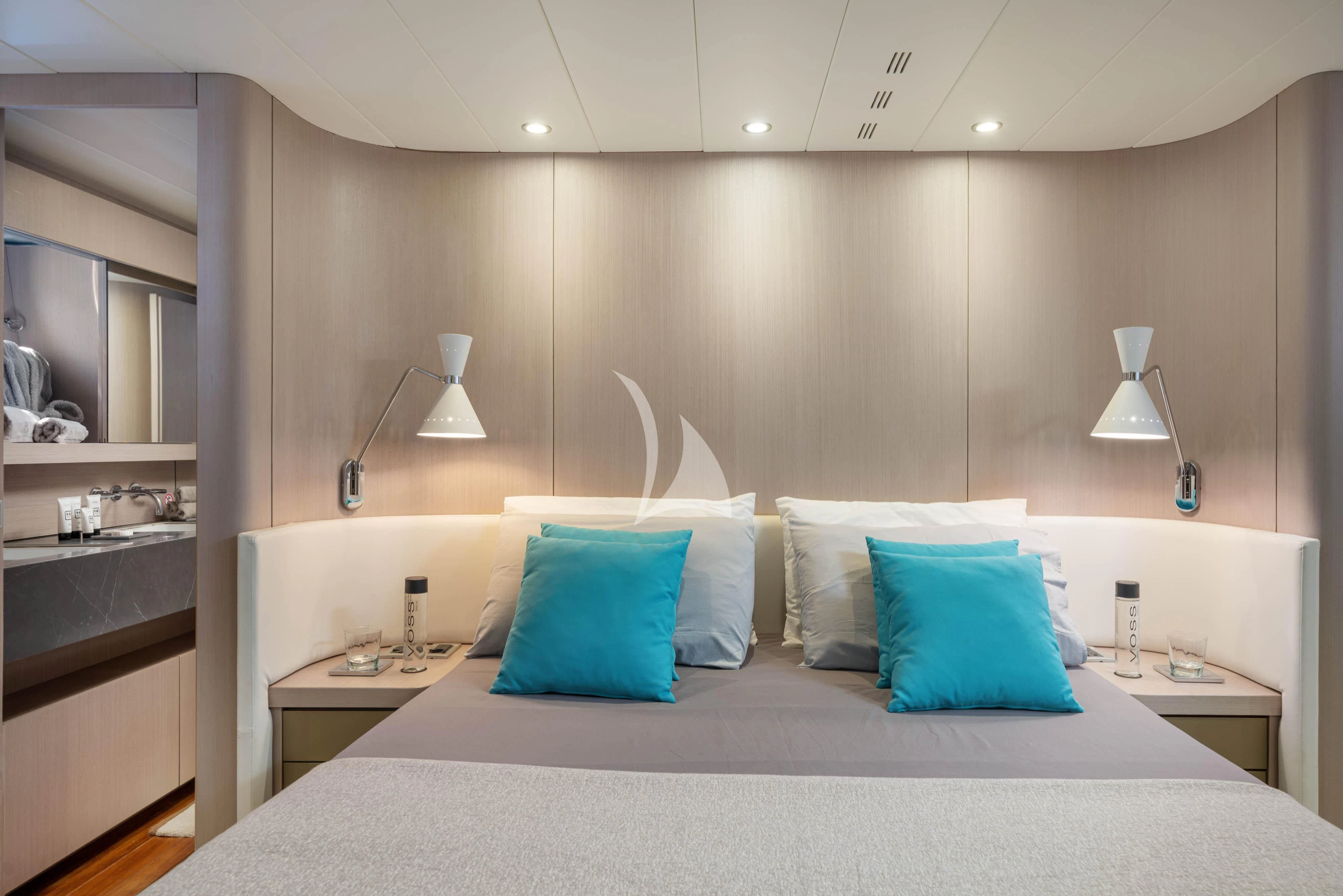 a bed with a white bed spread aboard MINOU Yacht for Sale