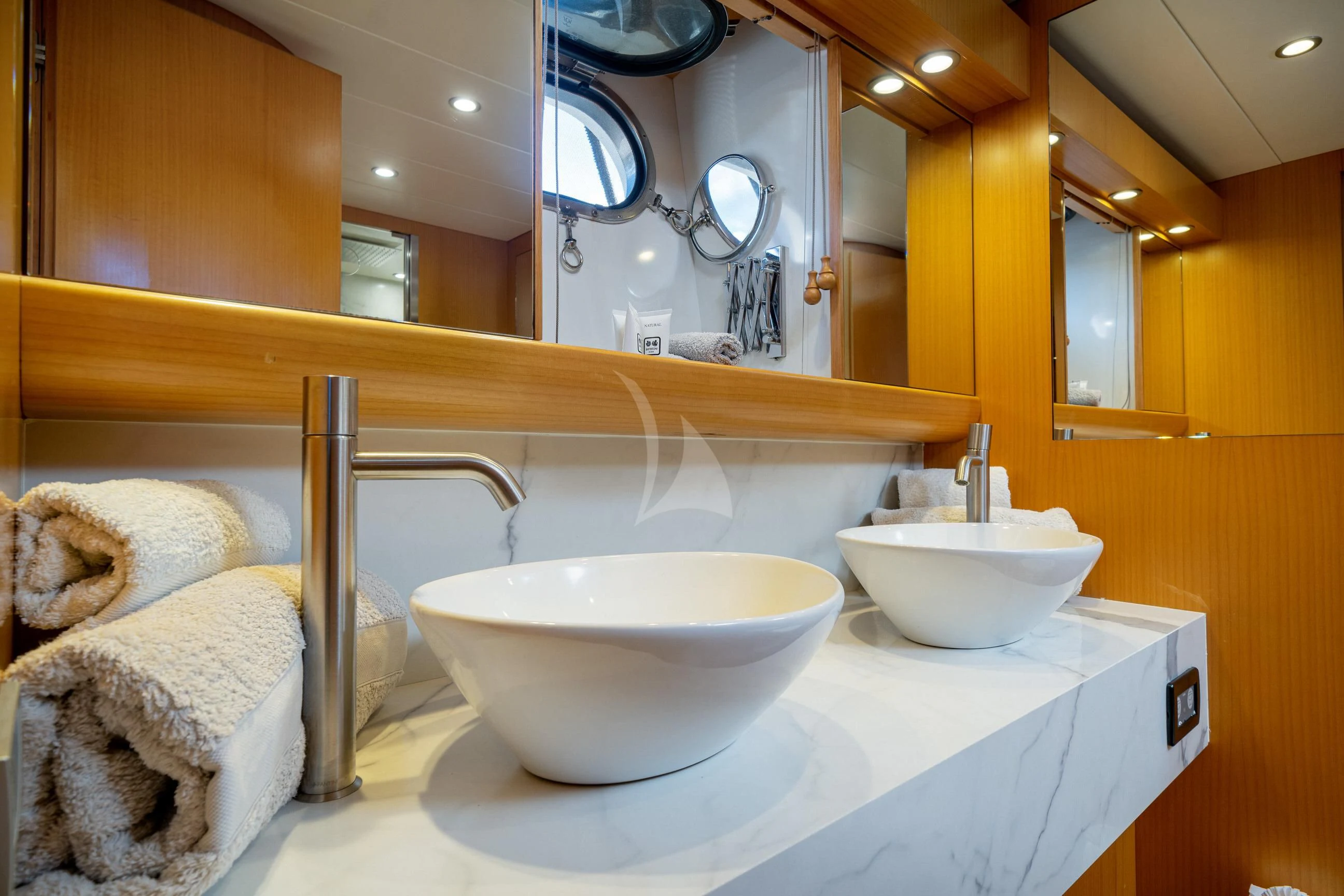 a bathroom with a sink and a large mirror aboard MINOU Yacht for Sale