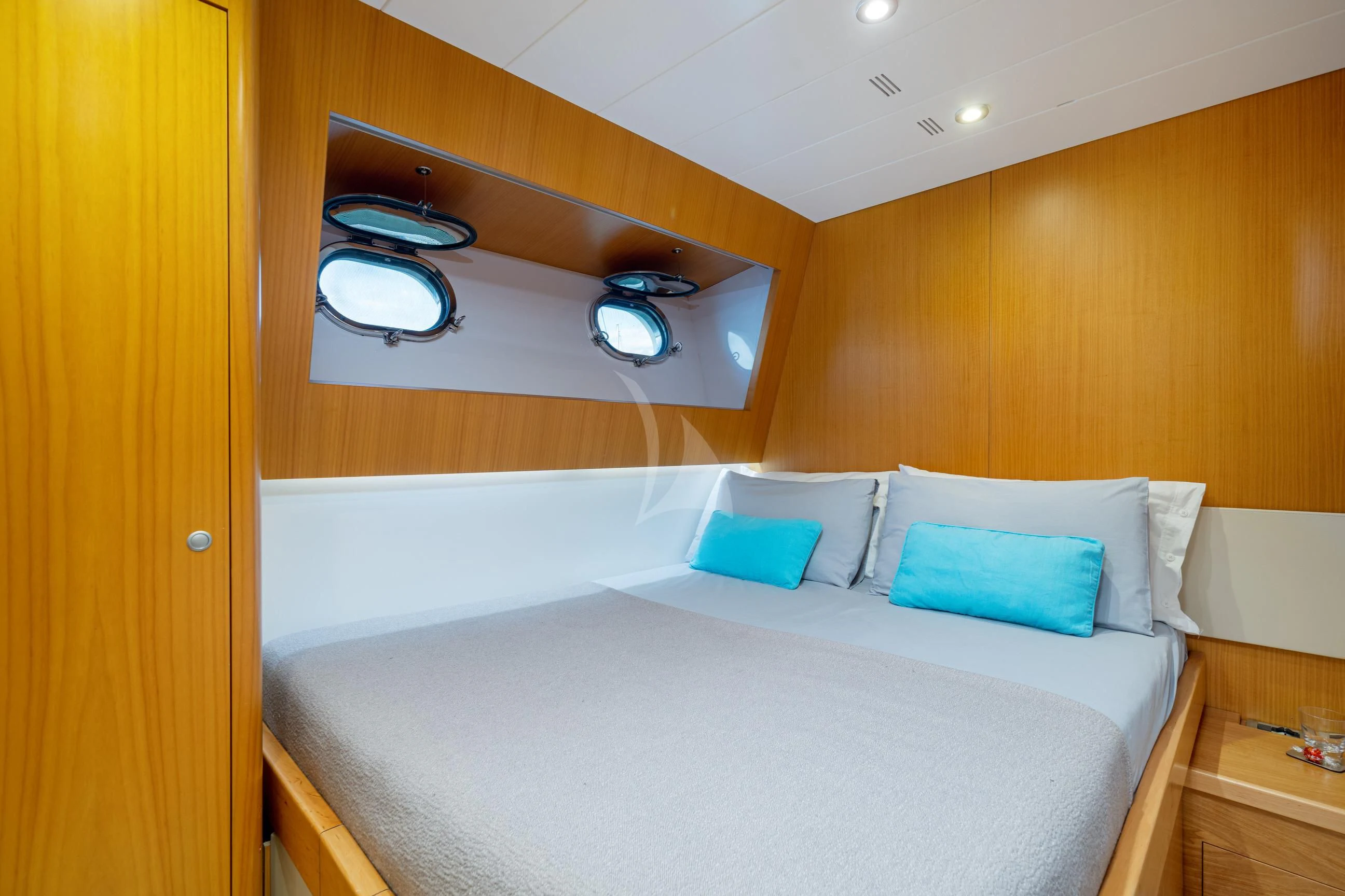 a bed with a white bed aboard MINOU Yacht for Sale