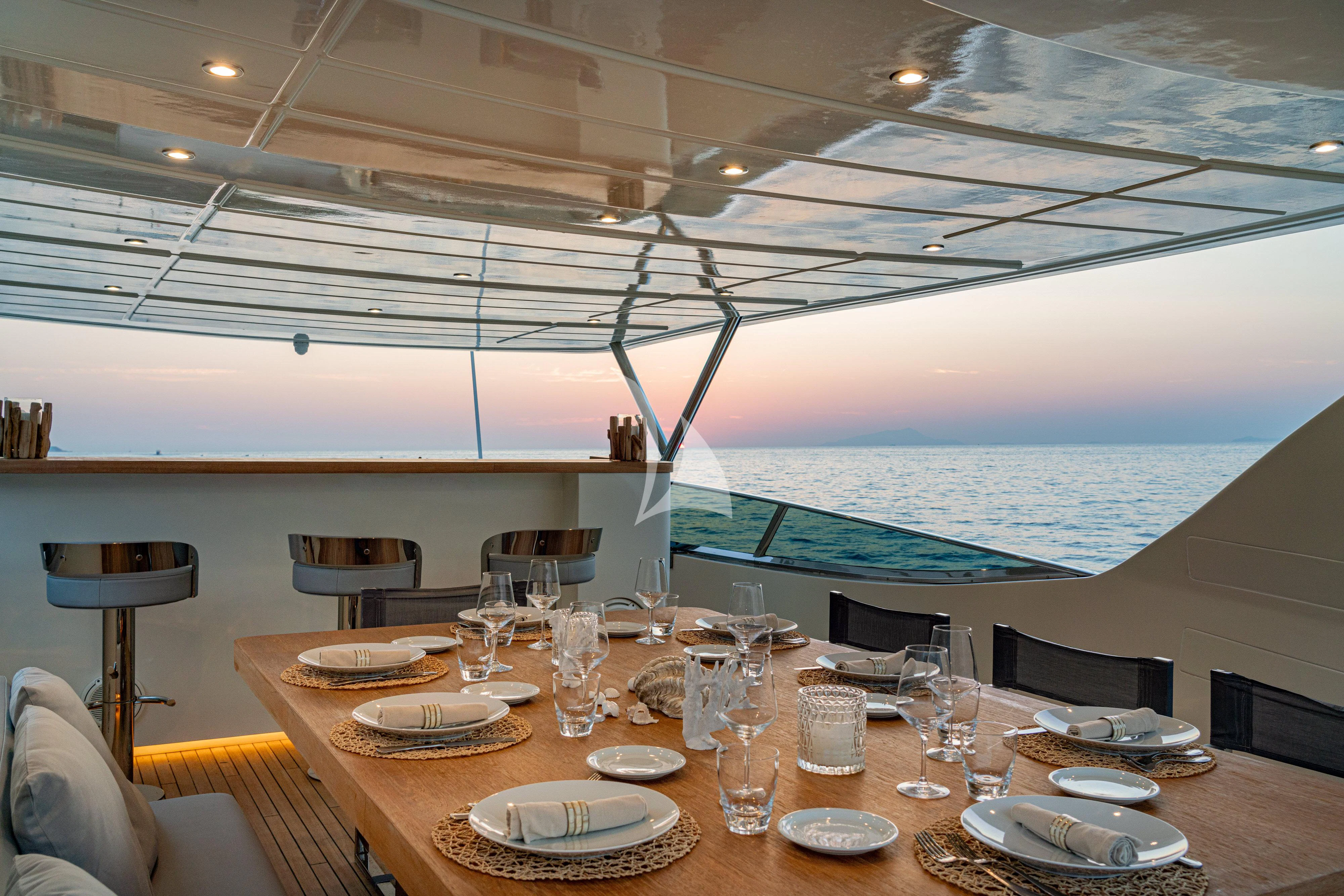 a table with plates and glasses on it aboard MINOU Yacht for Sale