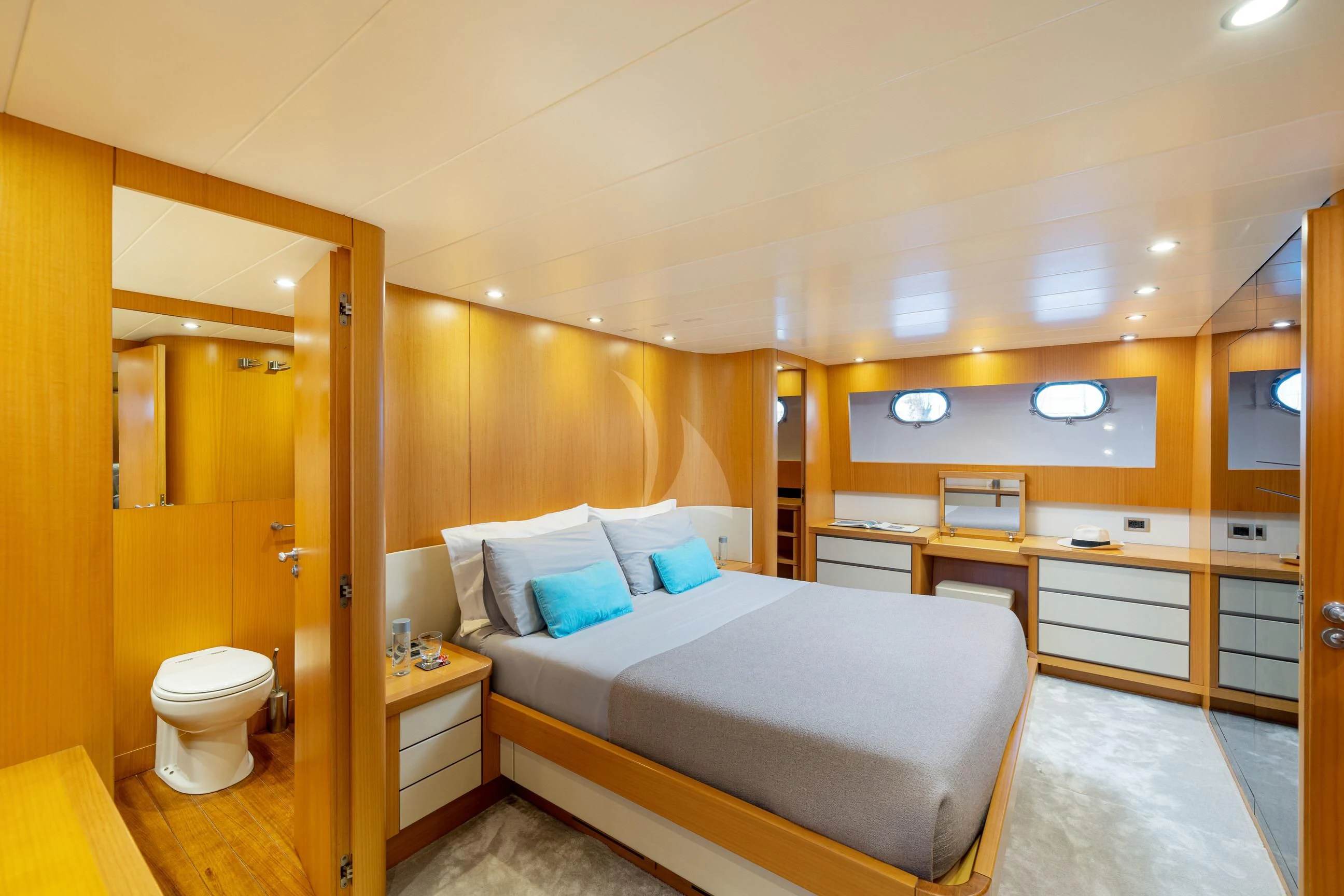 a bedroom with a bed and a mirror aboard MINOU Yacht for Sale