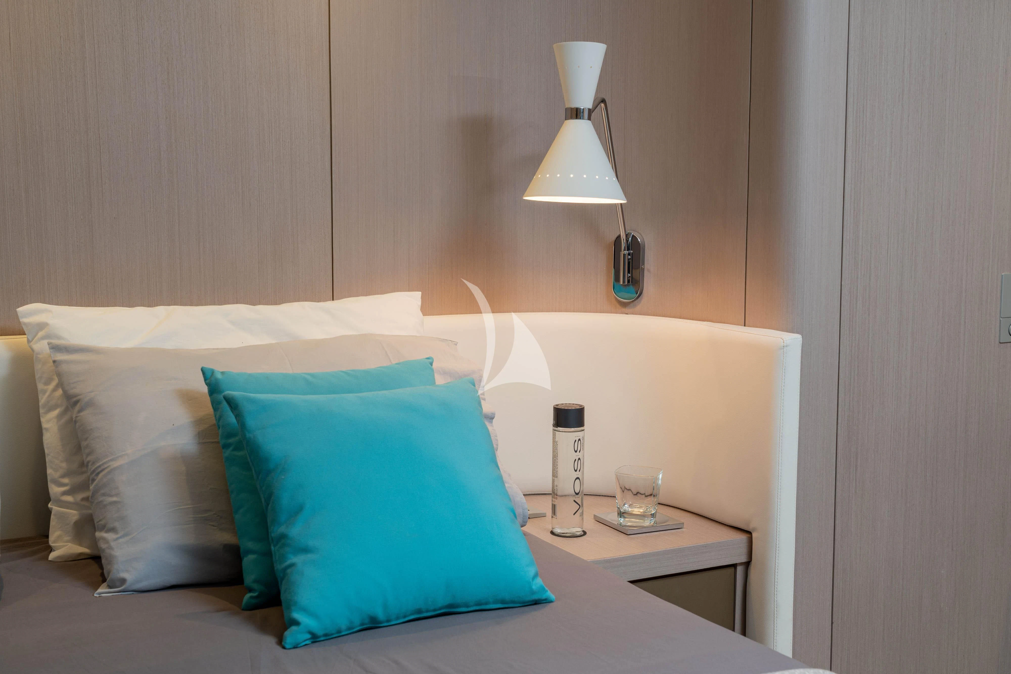 a bed with a blue pillow aboard MINOU Yacht for Sale