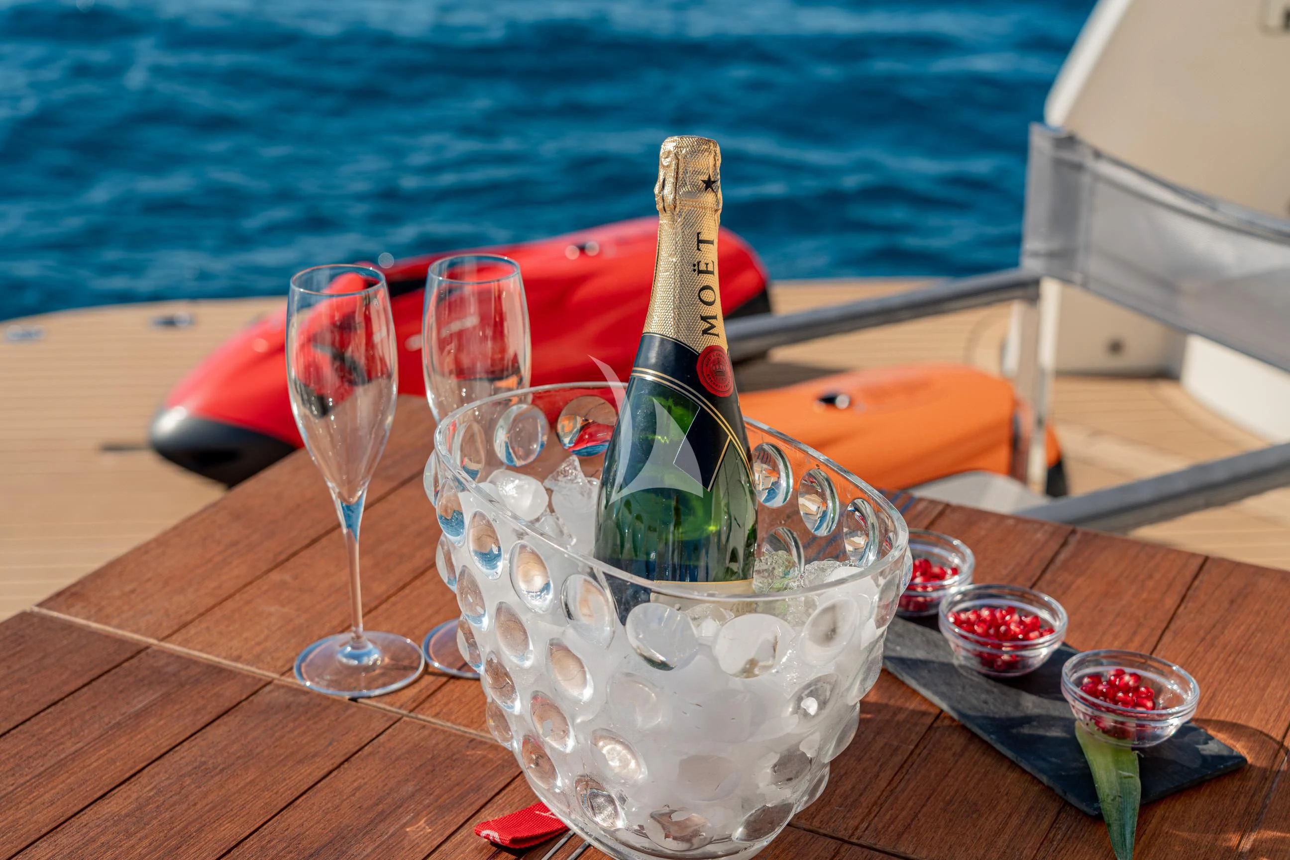 a bottle of champagne on a table aboard MINOU Yacht for Sale
