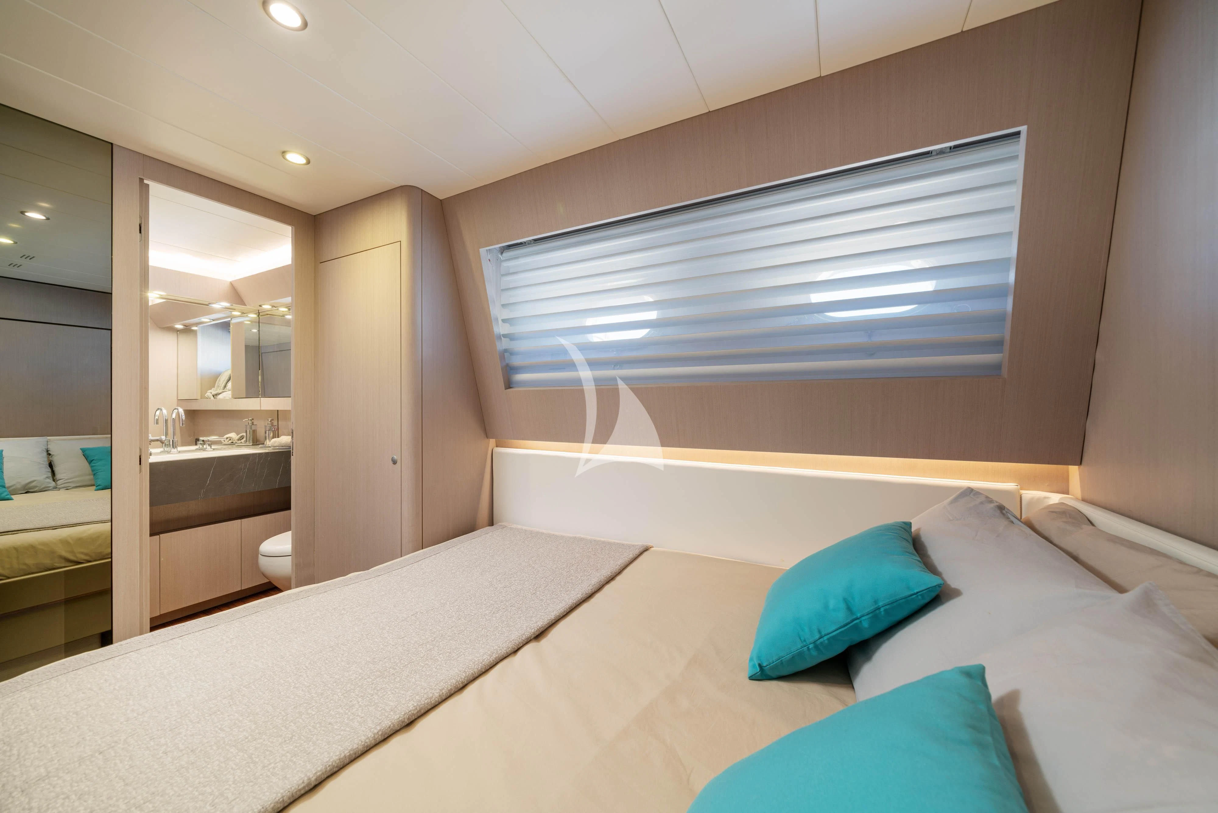 a bedroom with a bed and a window aboard MINOU Yacht for Sale