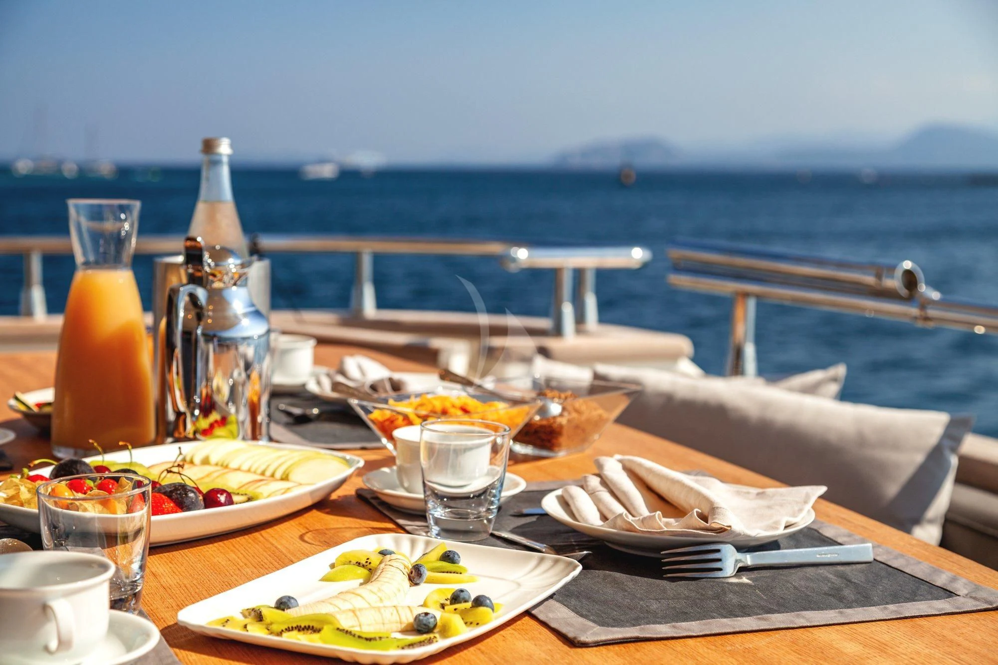 a table with food and drinks on it aboard MINOU Yacht for Sale