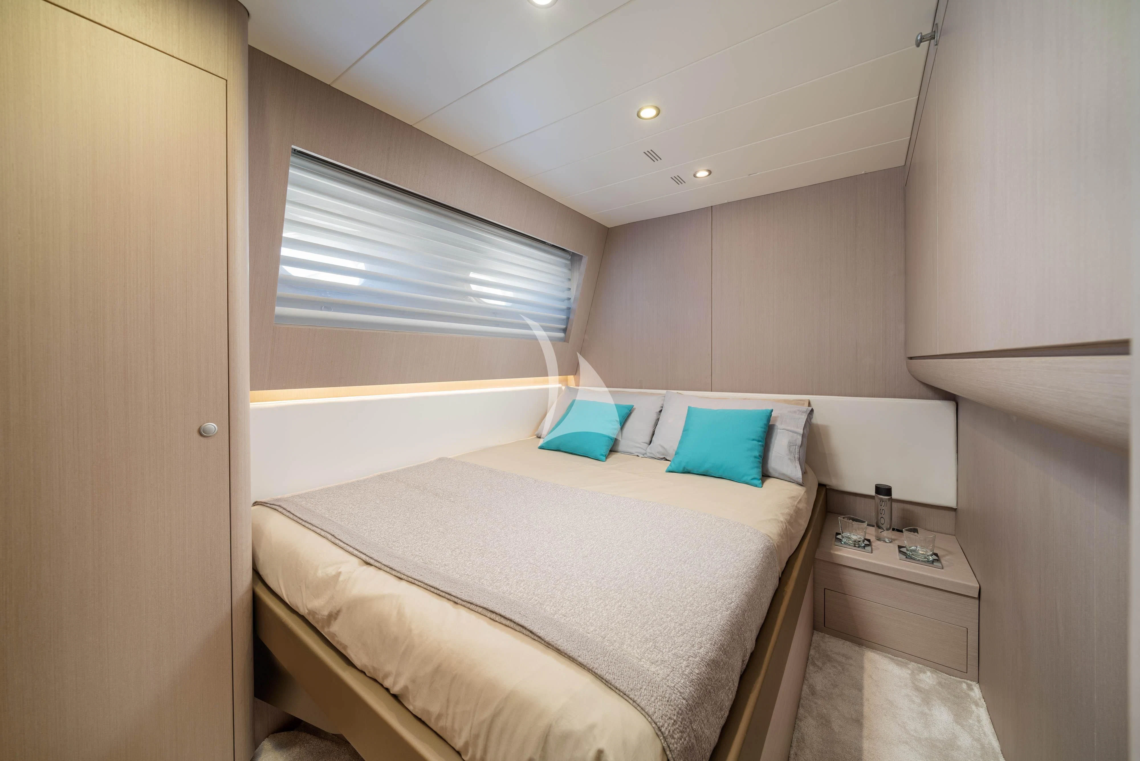 a small bedroom with a bed aboard MINOU Yacht for Sale