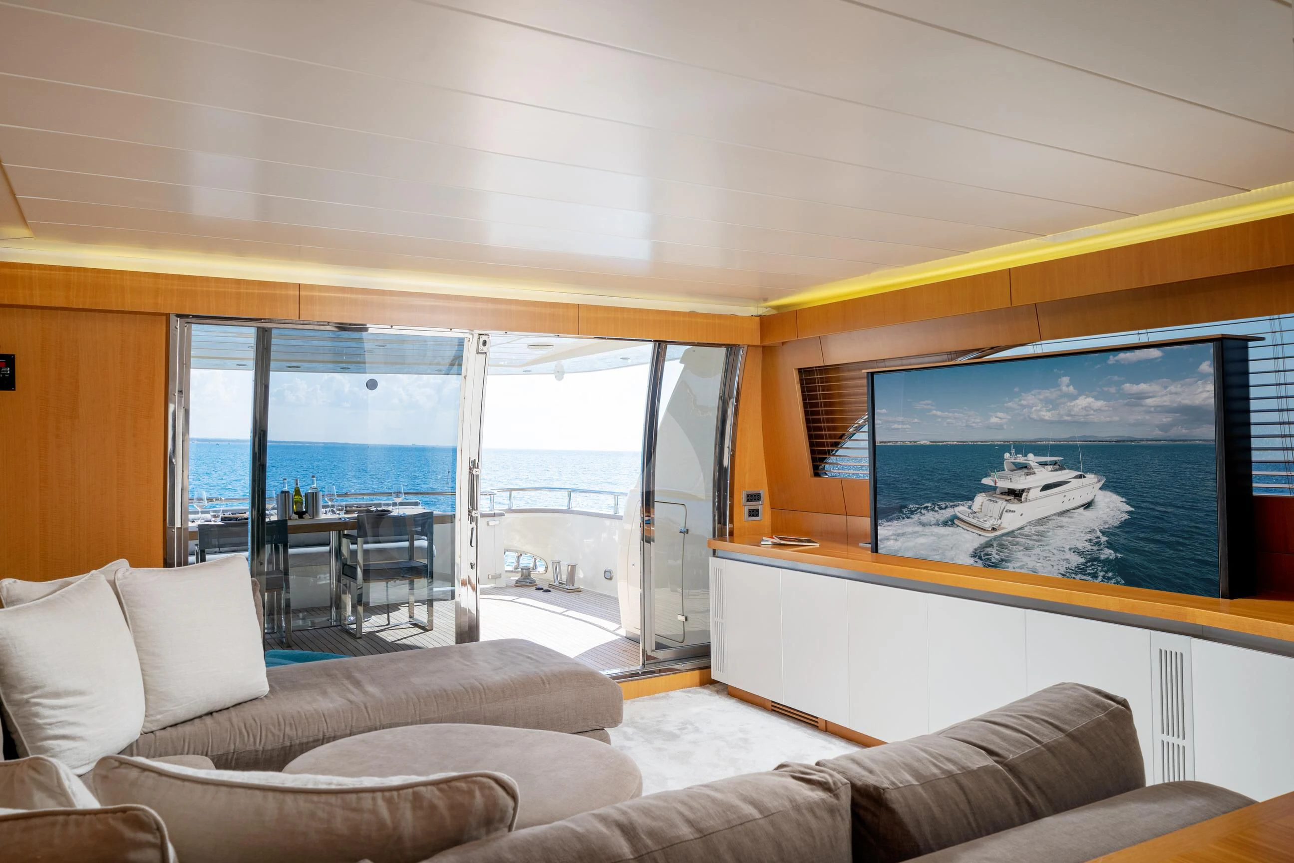 a living room with a large screen aboard MINOU Yacht for Sale