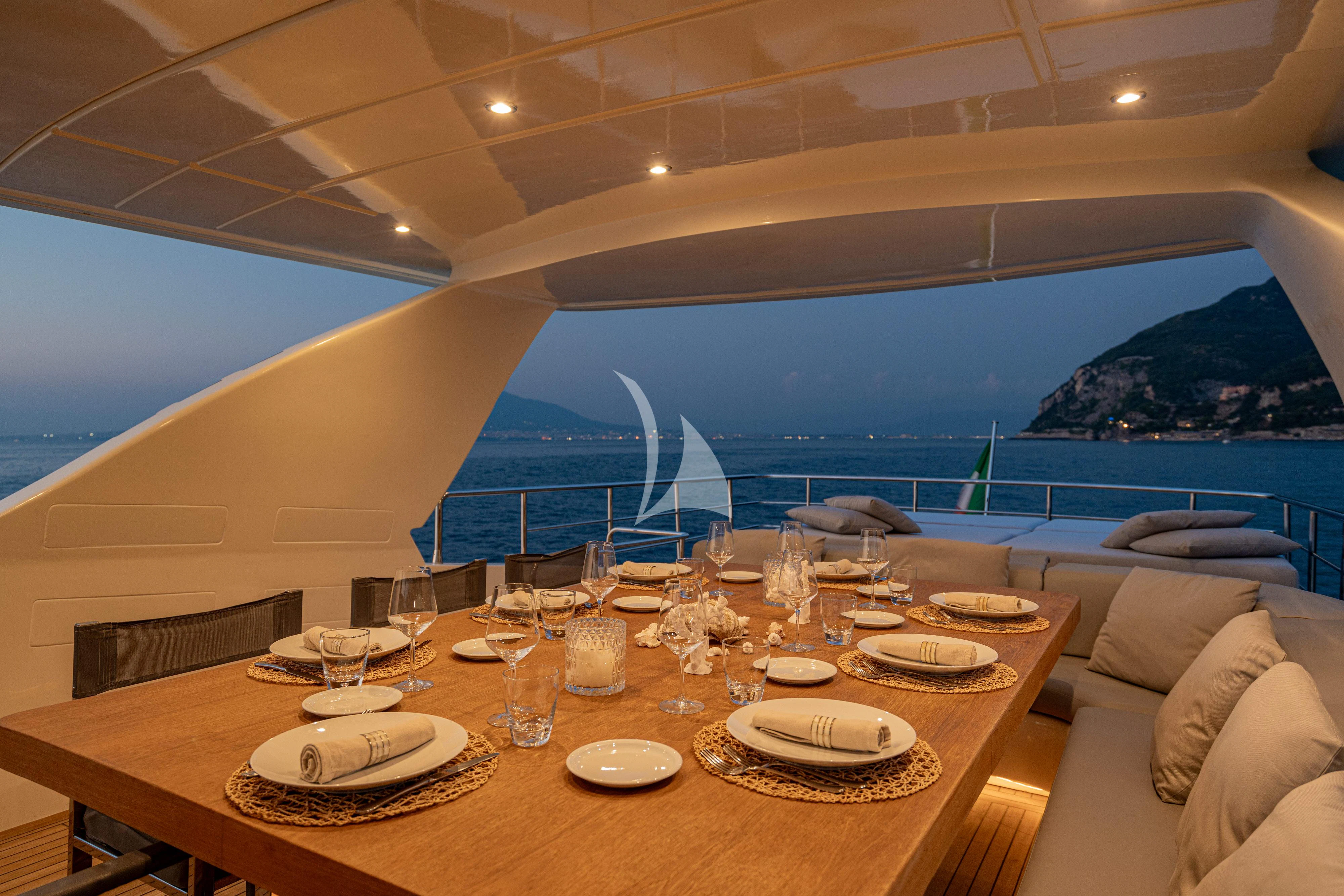 a table with plates and glasses on it aboard MINOU Yacht for Sale
