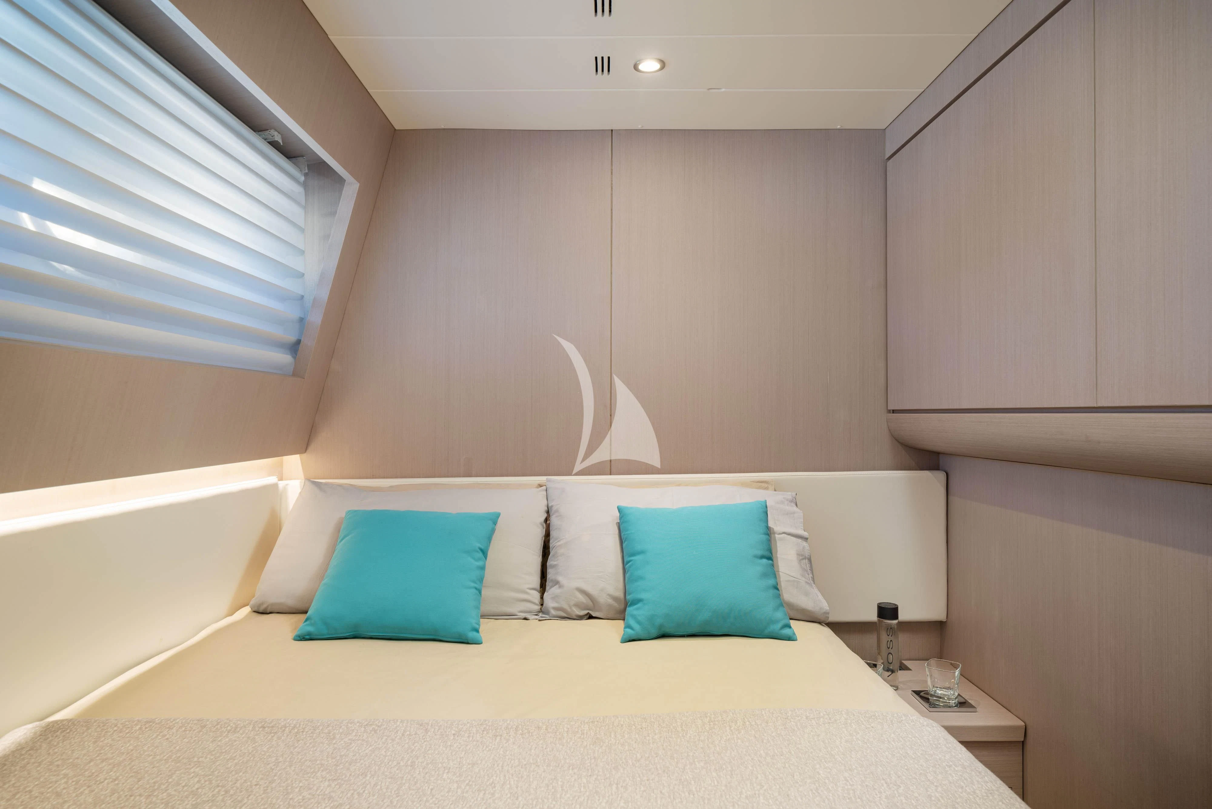a bed with a white bed spread aboard MINOU Yacht for Sale