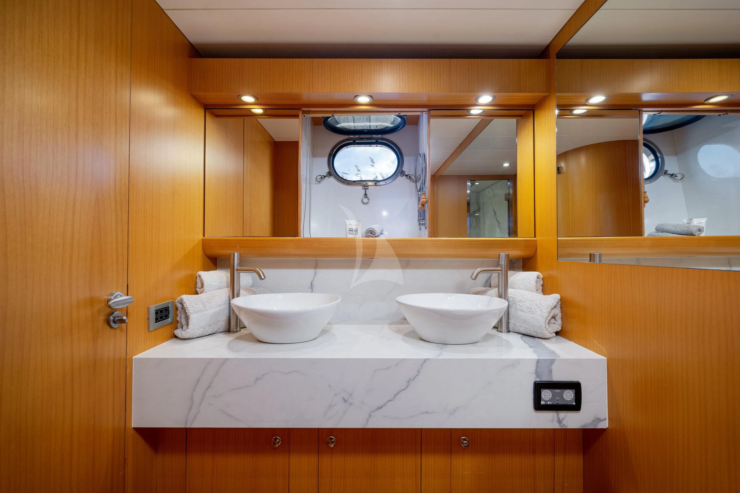 a bathroom with sinks and a large clock aboard MINOU Yacht for Sale