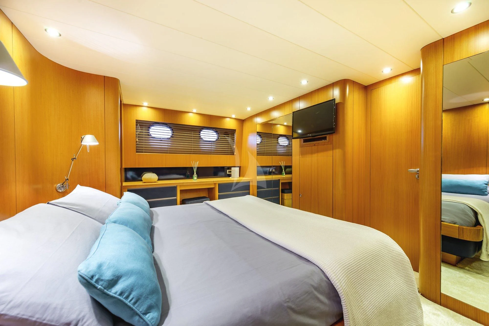 a bedroom with a bed and a television aboard MINOU Yacht for Sale