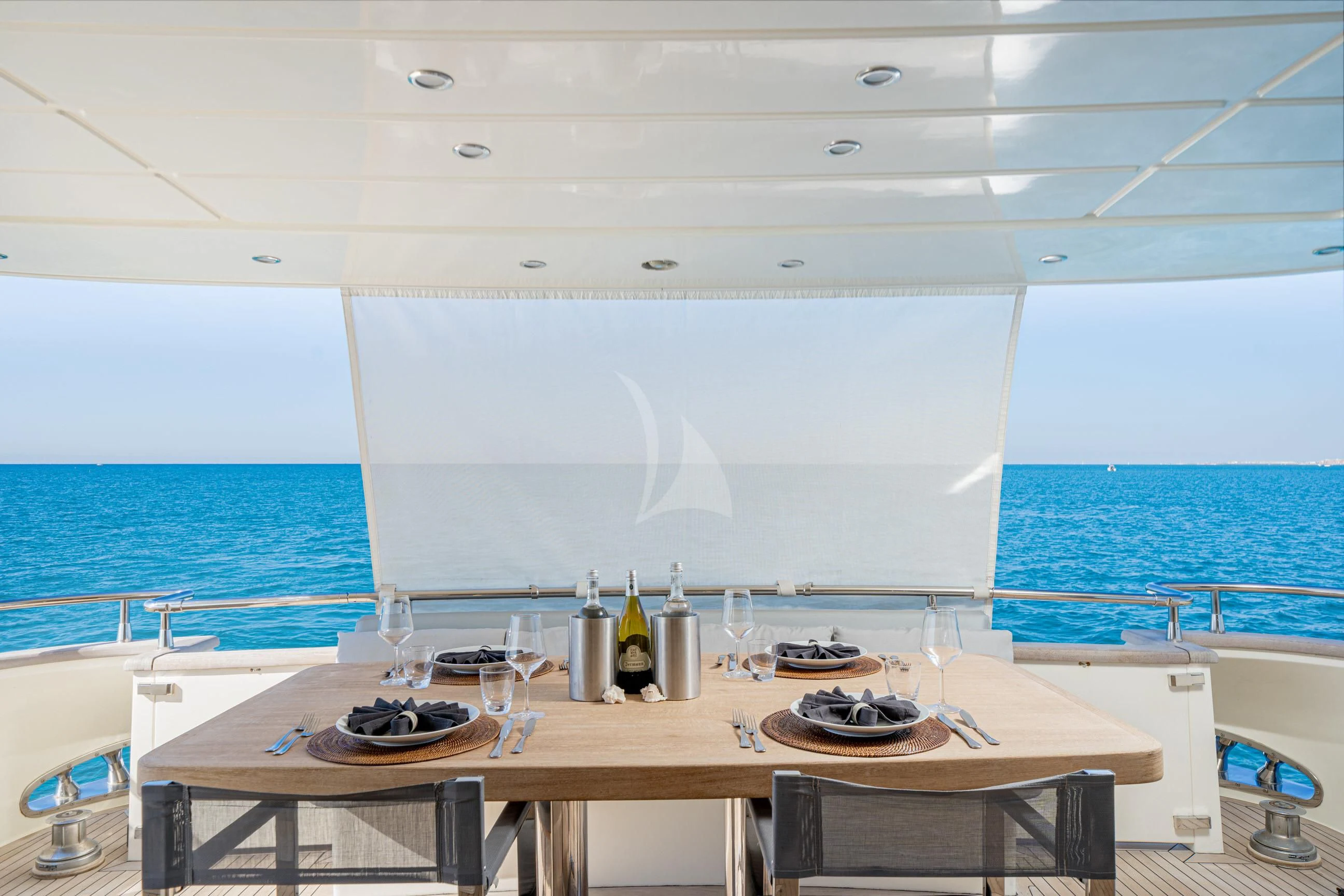 a table with plates and glasses on it aboard MINOU Yacht for Sale