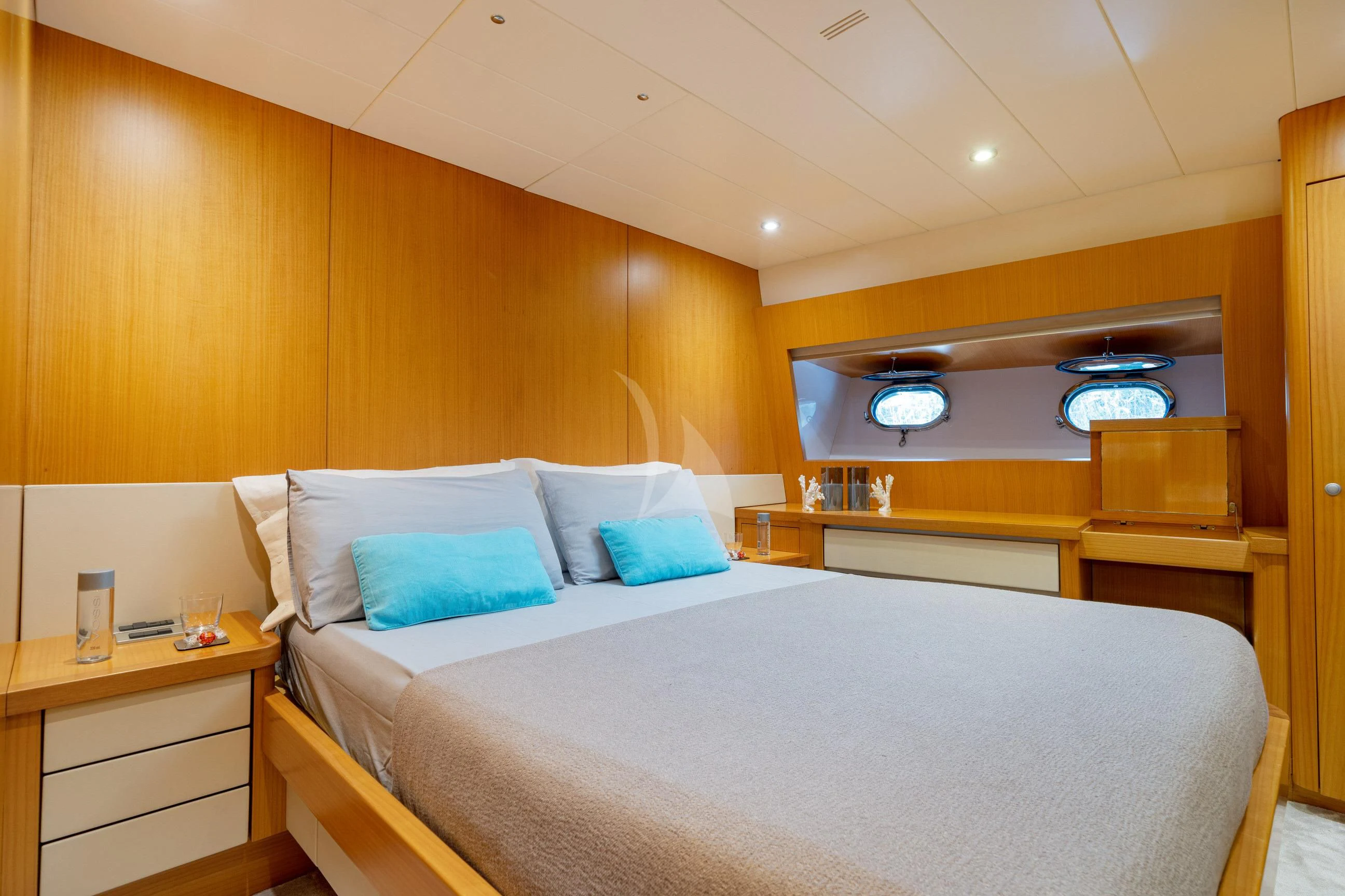 a bed with a white bed spread aboard MINOU Yacht for Sale