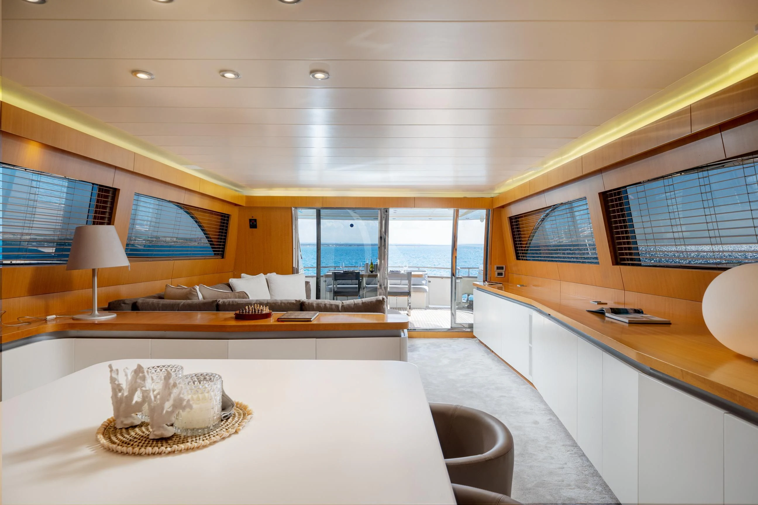 a room with a large window and a large white table with a white table and chairs aboard MINOU Yacht for Sale