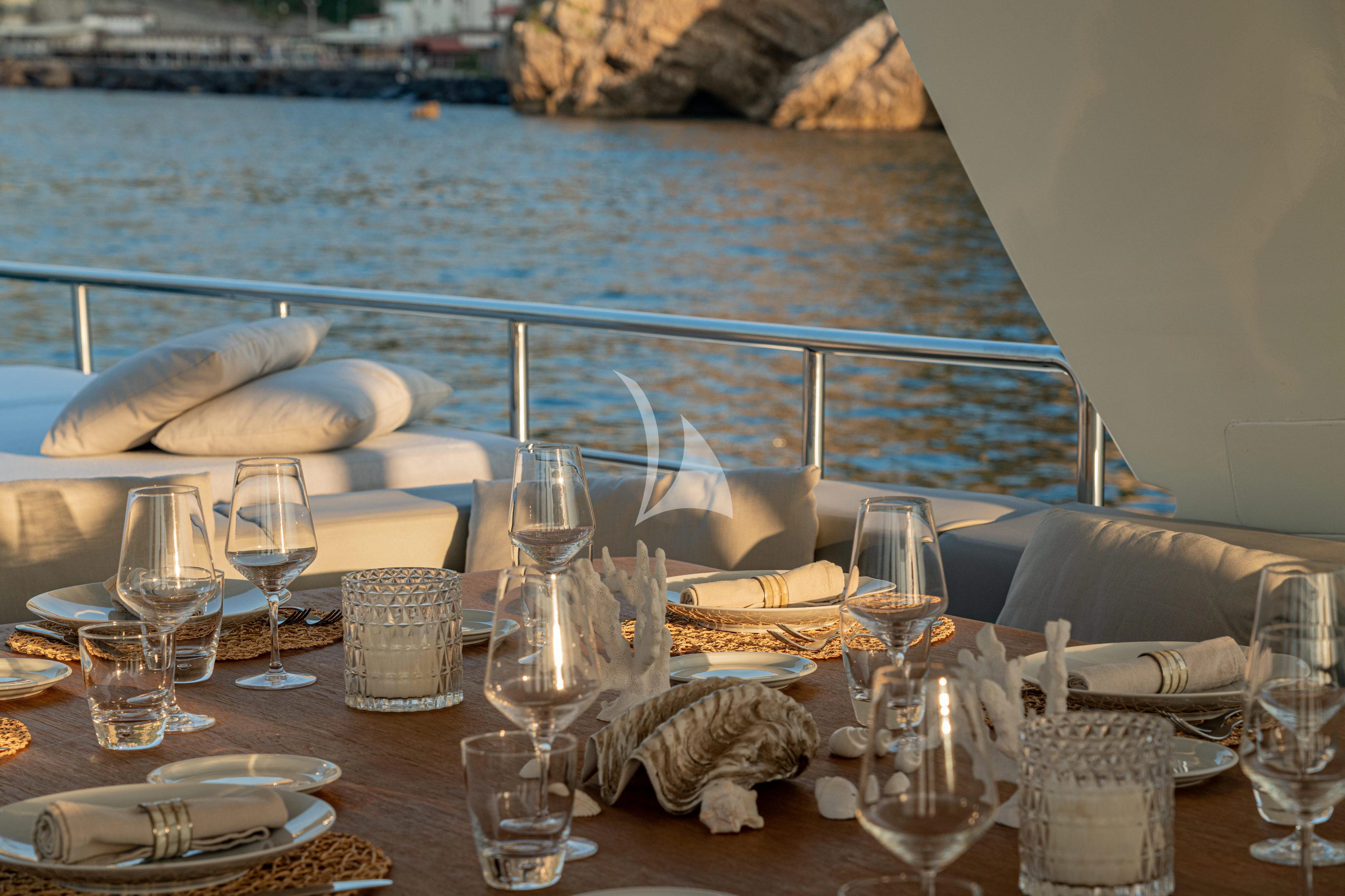 a table with wine glasses and food on it aboard MINOU Yacht for Sale