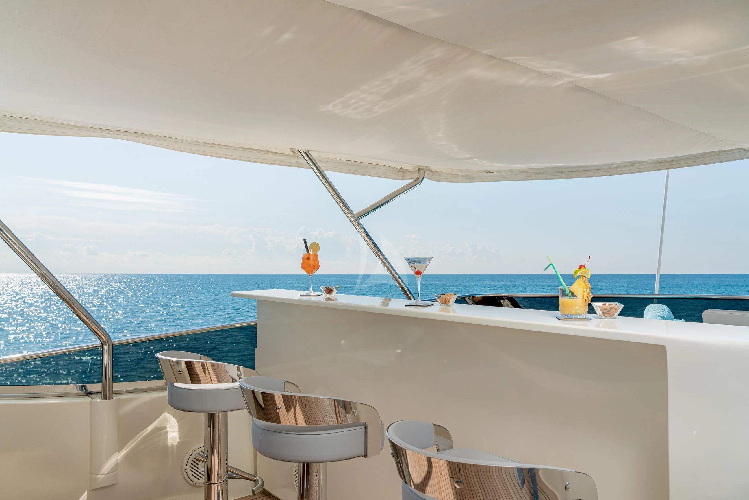 a table with chairs and a window overlooking the ocean aboard MINOU Yacht for Sale