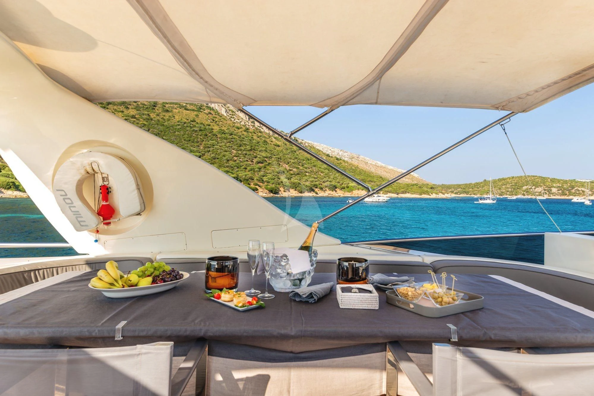 a table with food and drinks on it aboard MINOU Yacht for Sale