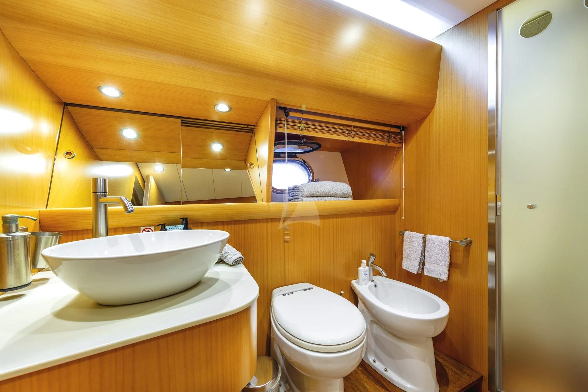 a bathroom with a sink toilet and a mirror aboard MINOU Yacht for Sale
