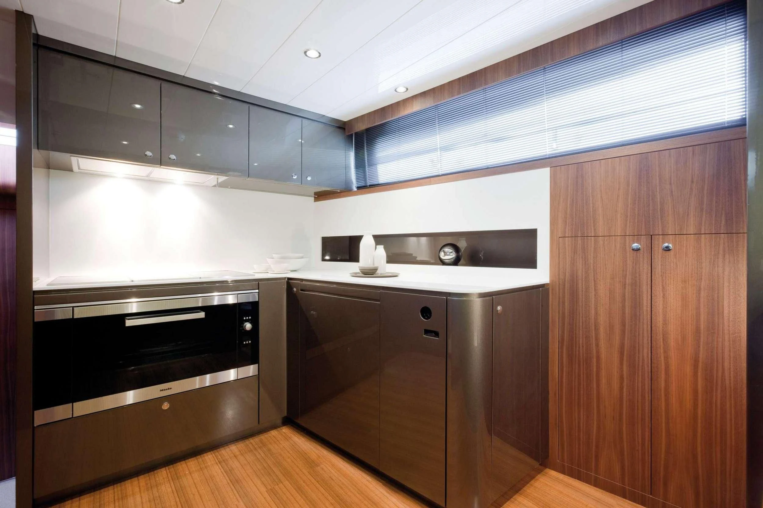 a kitchen with black cabinets aboard PRIVILEGIO Yacht for Sale
