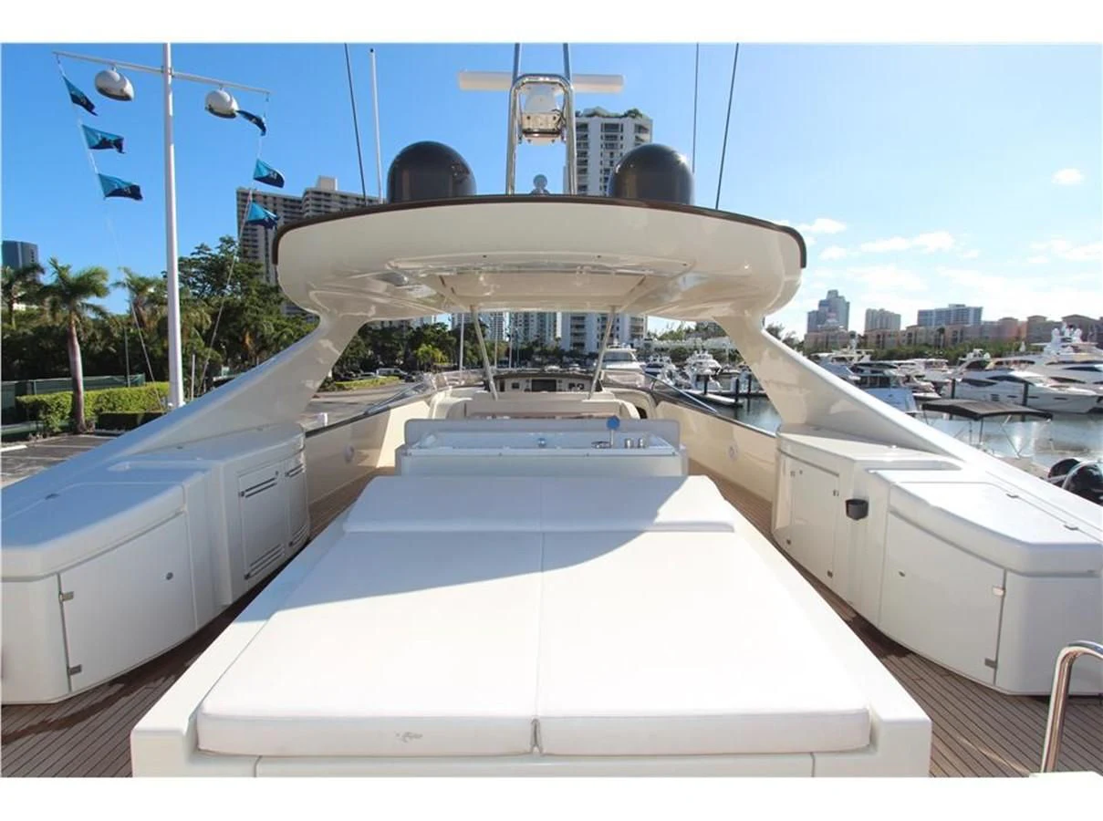 a large white boat in a harbor aboard PRIVILEGIO Yacht for Sale