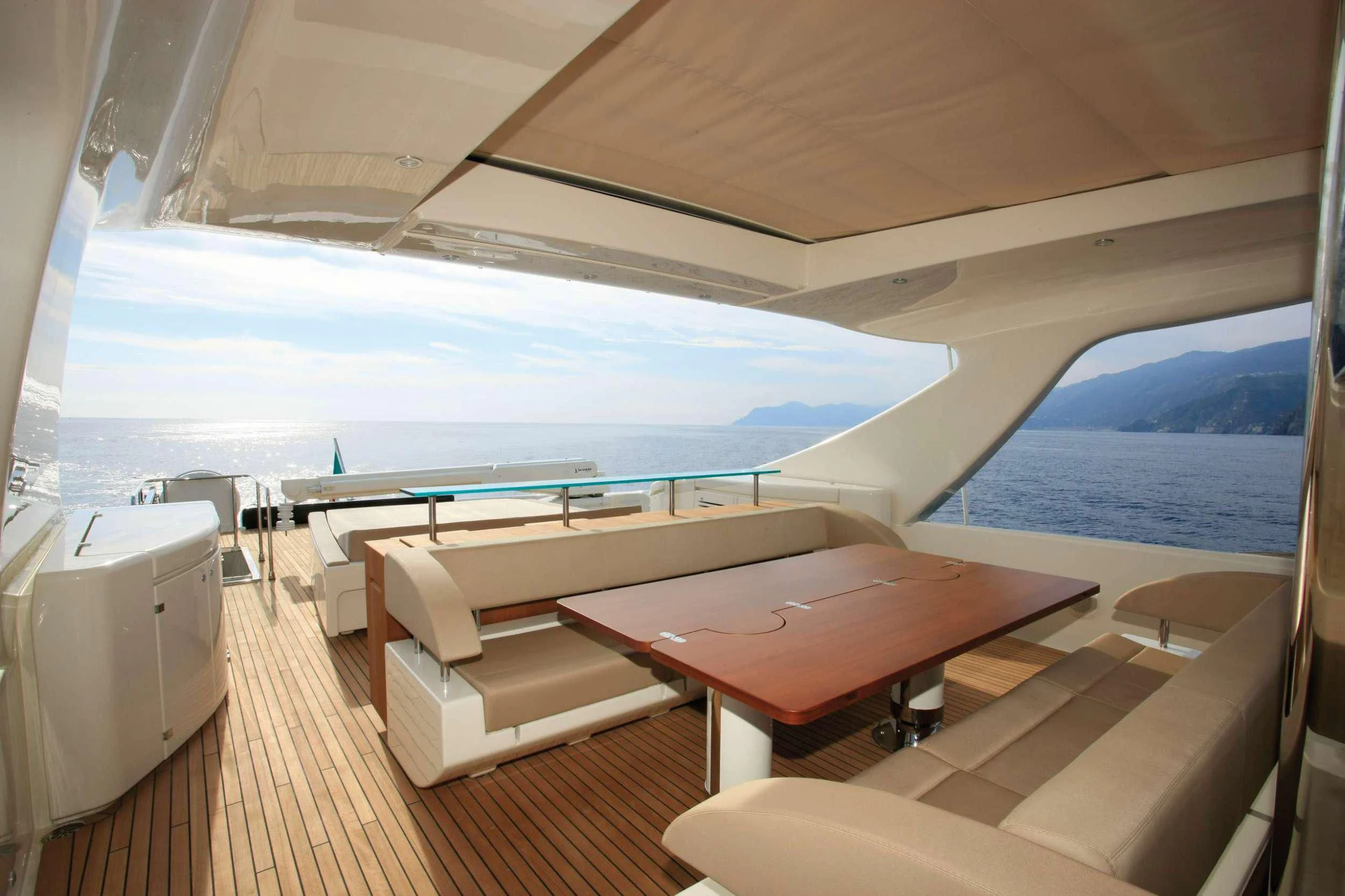 a room with a view of the ocean and the deck aboard PRIVILEGIO Yacht for Sale