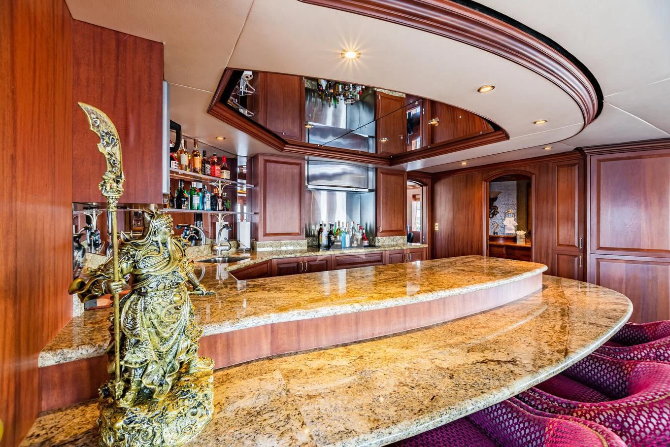 a large room with a large marble table and a large glass vase with a gold candle in it aboard SHOGUN Yacht for Sale