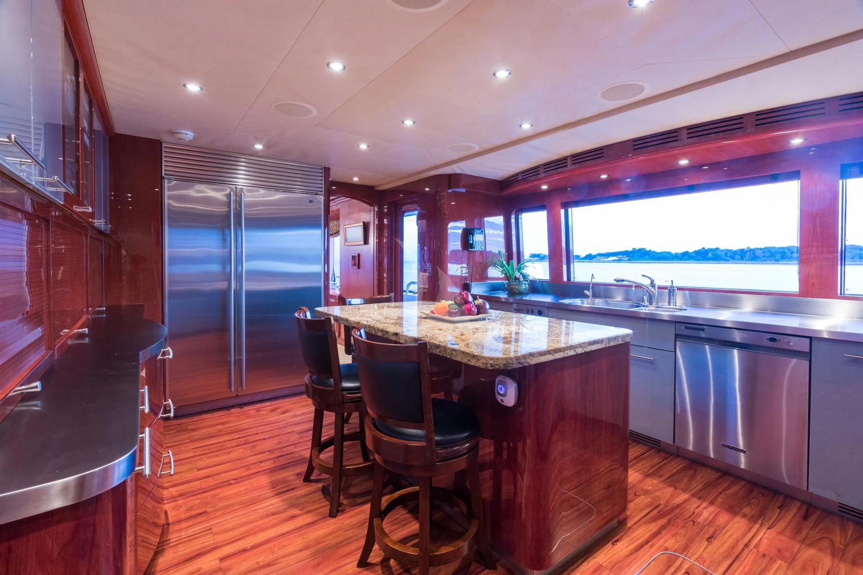 a kitchen with a bar and a table aboard SHOGUN Yacht for Sale