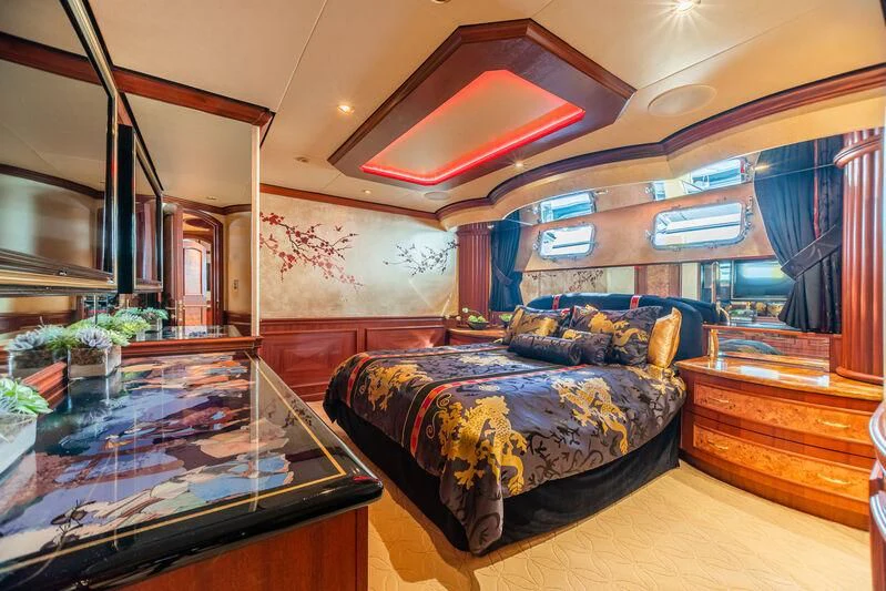 a bedroom with a bed and a desk aboard SHOGUN Yacht for Sale