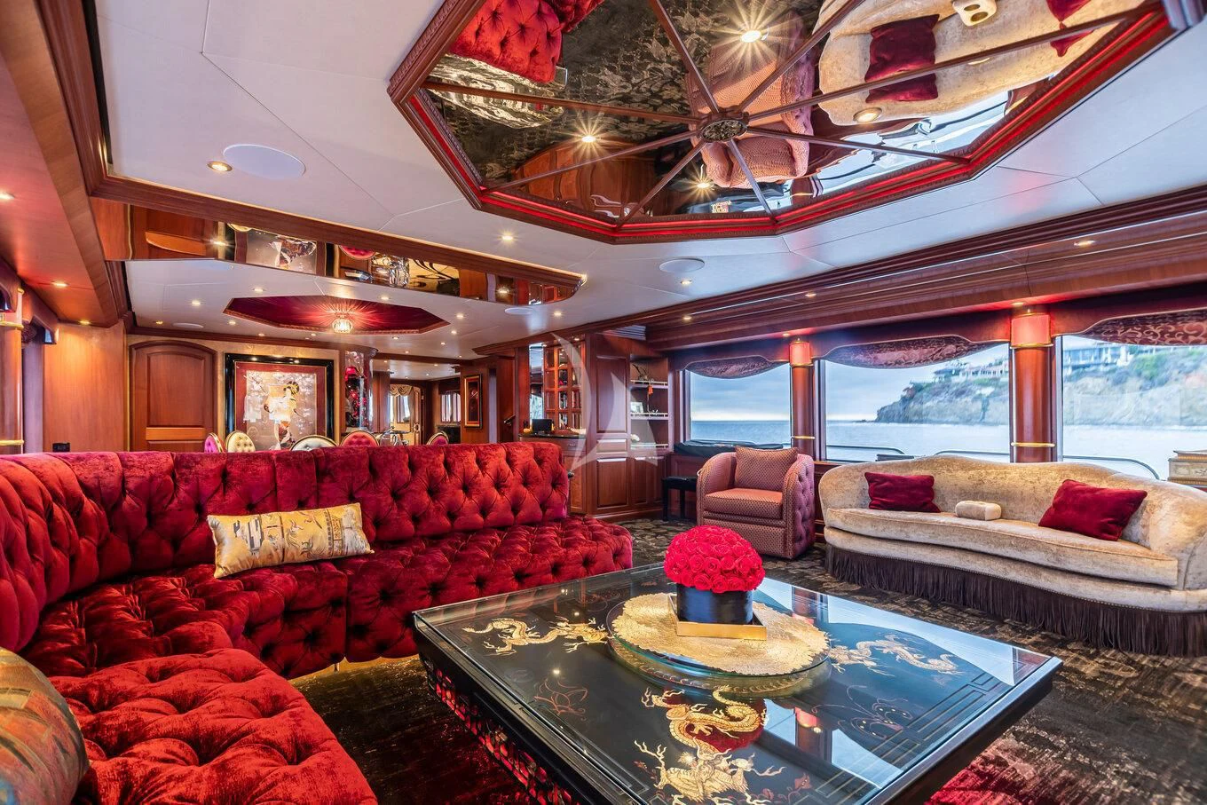 a living room with a large chandelier aboard SHOGUN Yacht for Sale