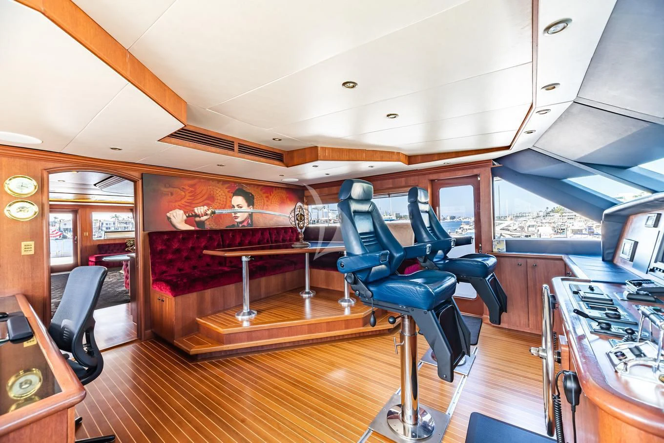 a room with a wood floor and a wood floor with a red couch and a wood table with aboard SHOGUN Yacht for Sale