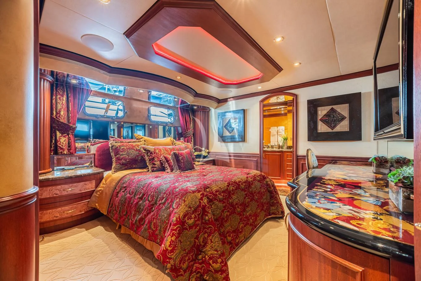 a bedroom with a bed and a table aboard SHOGUN Yacht for Sale