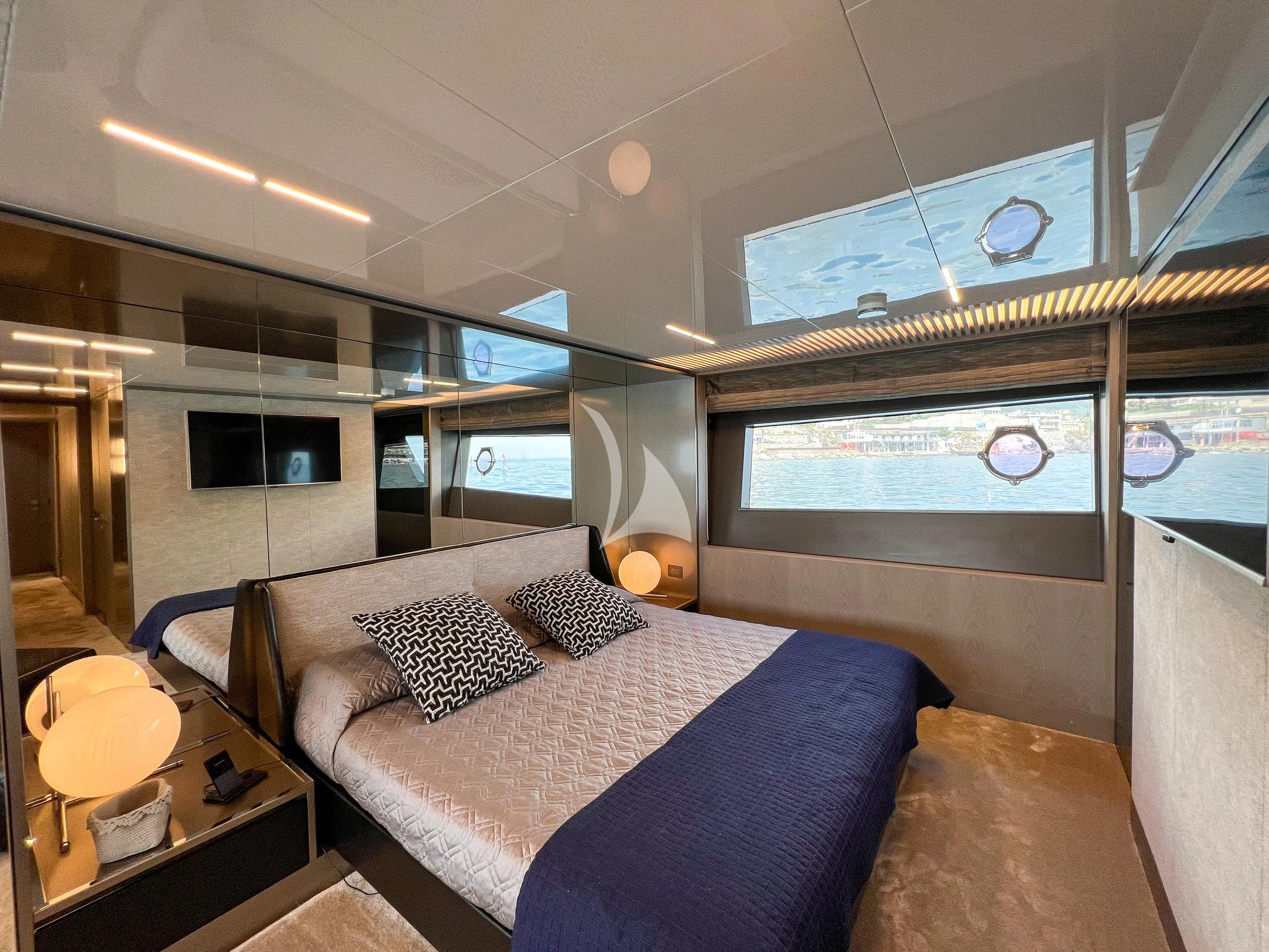 a bedroom with a bed and a table aboard E3 Yacht for Sale