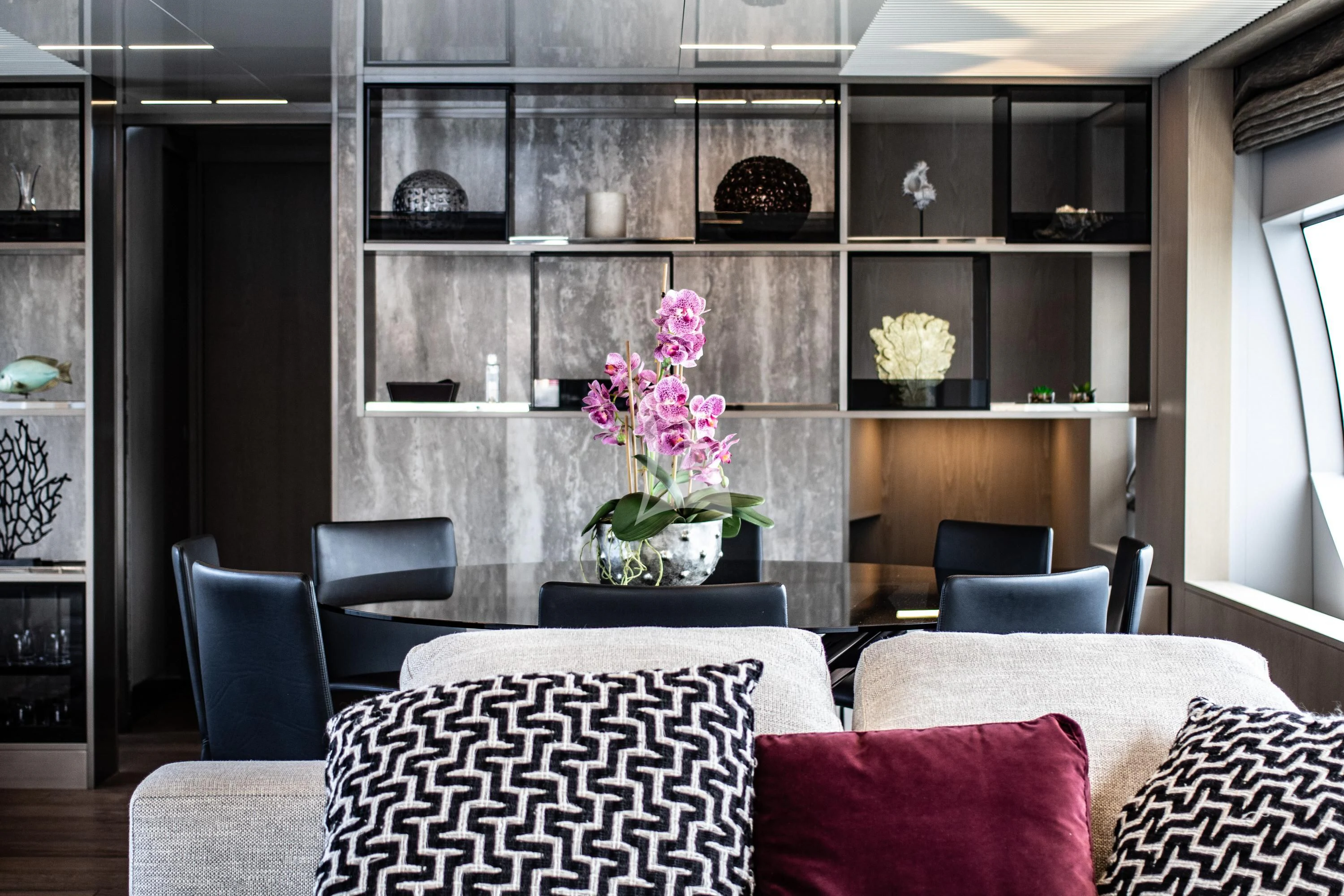 a room with a shelf and chairs aboard E3 Yacht for Sale