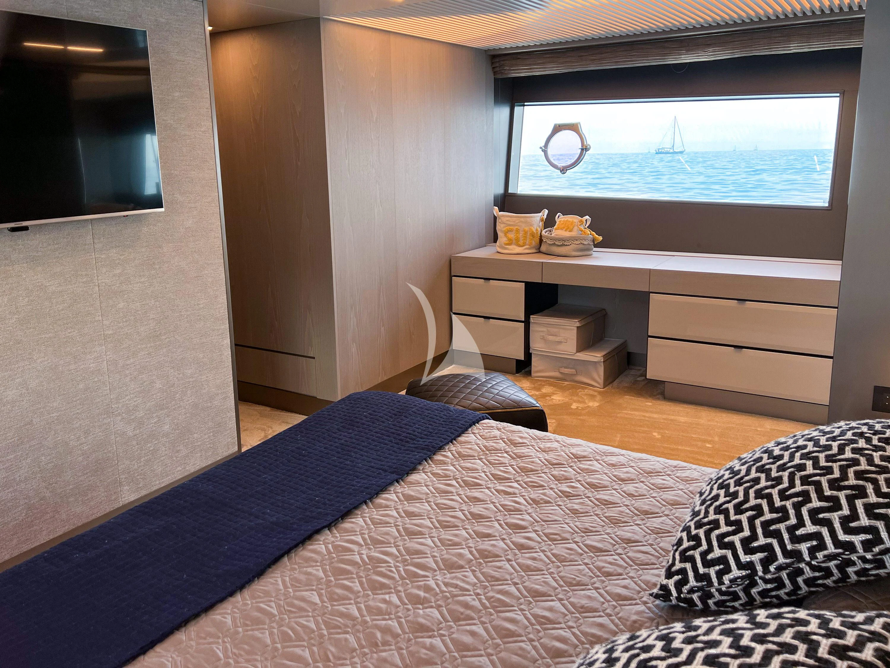a bedroom with a bed and a desk aboard E3 Yacht for Sale