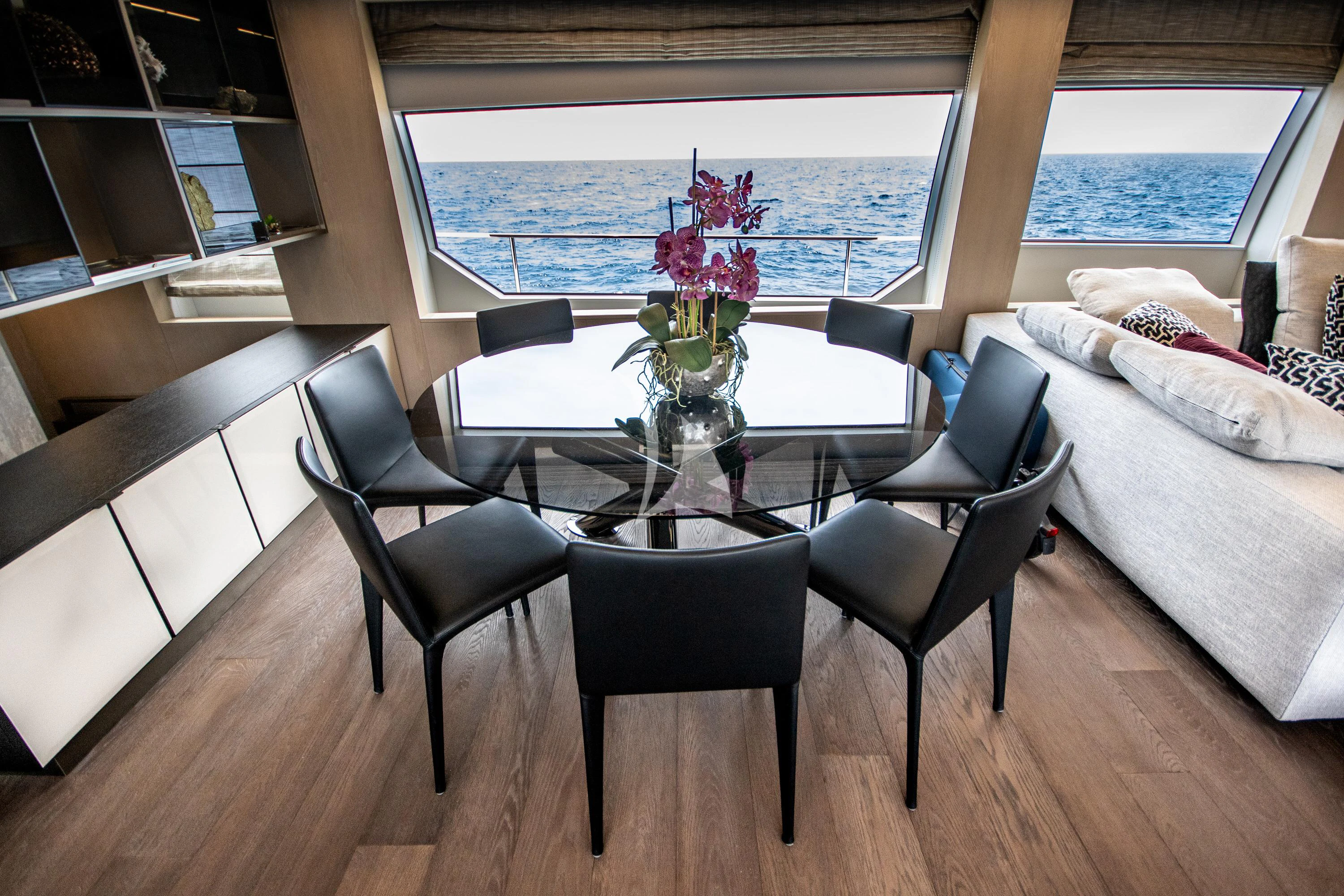 a table with chairs around it aboard E3 Yacht for Sale
