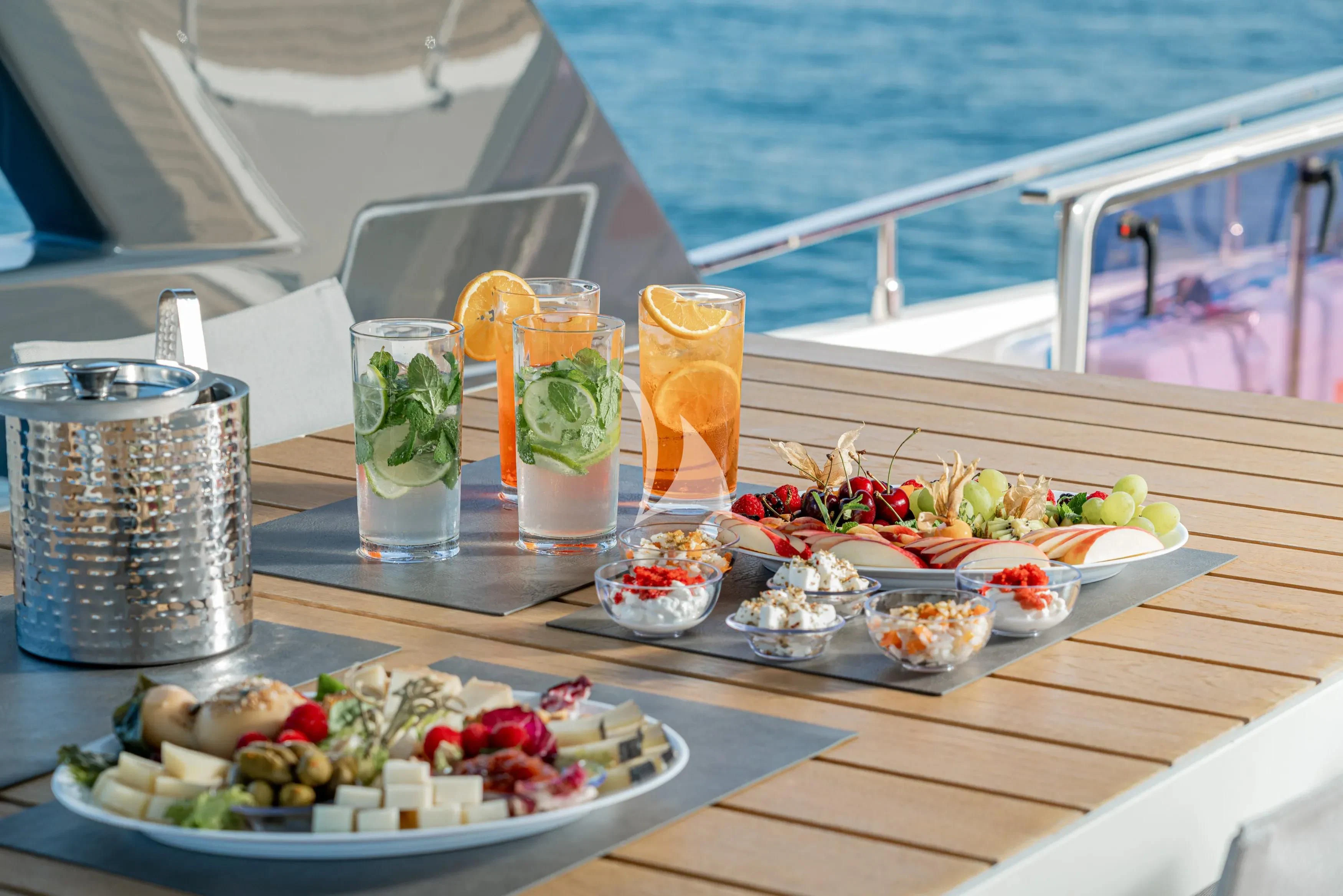 a table with food and drinks on it aboard E3 Yacht for Sale