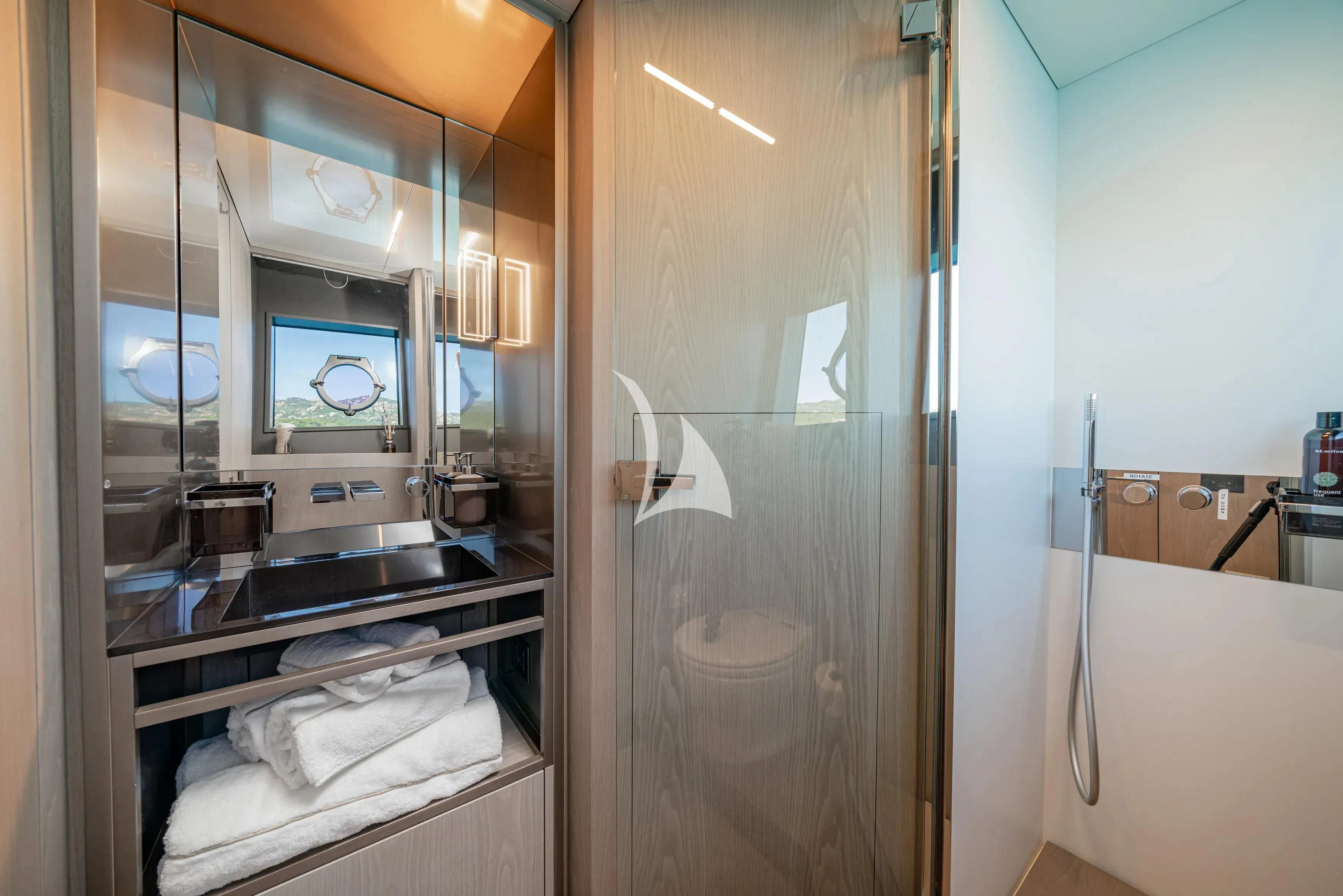 a bathroom with a glass shower aboard E3 Yacht for Sale