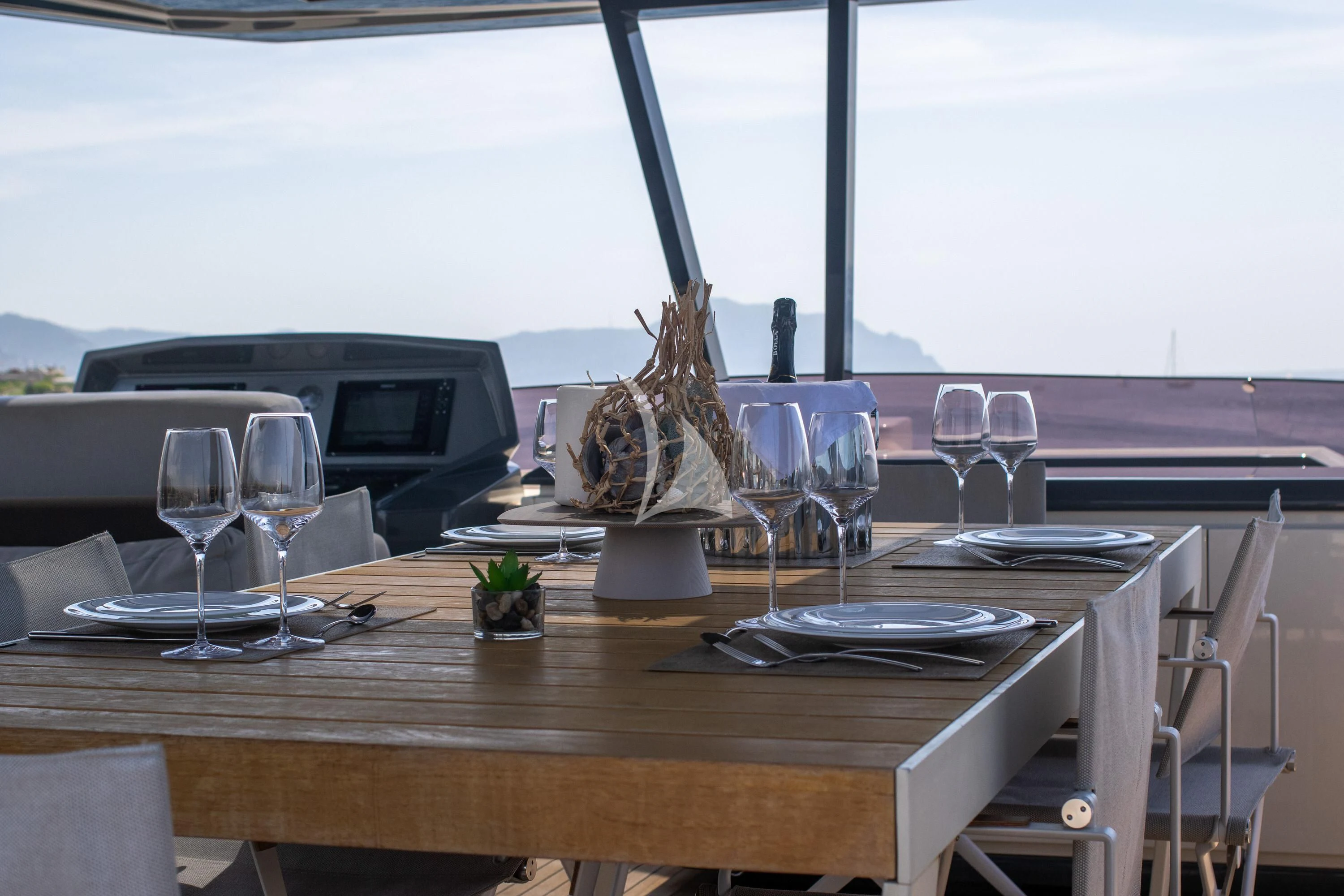 a table with wine glasses and a cactus on it aboard E3 Yacht for Sale