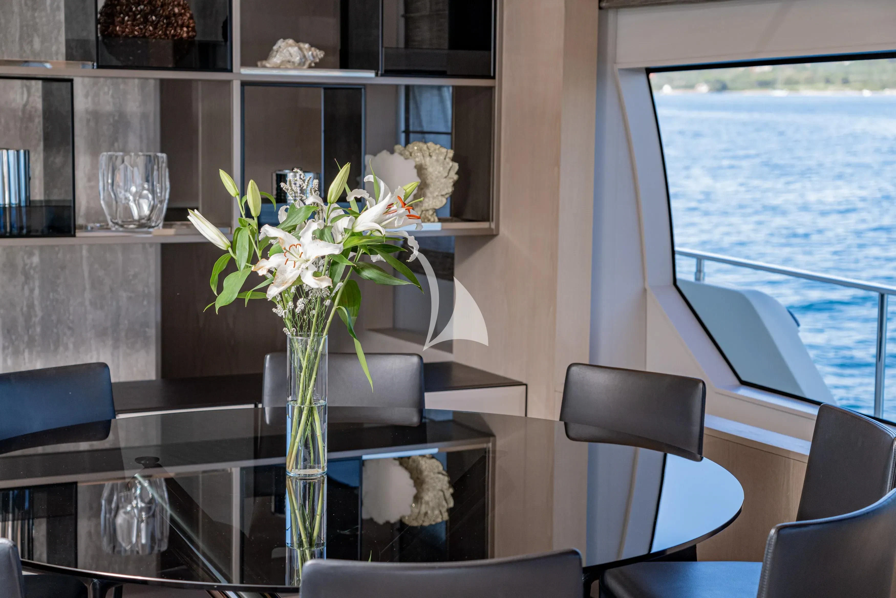 a vase with flowers on a table aboard E3 Yacht for Sale