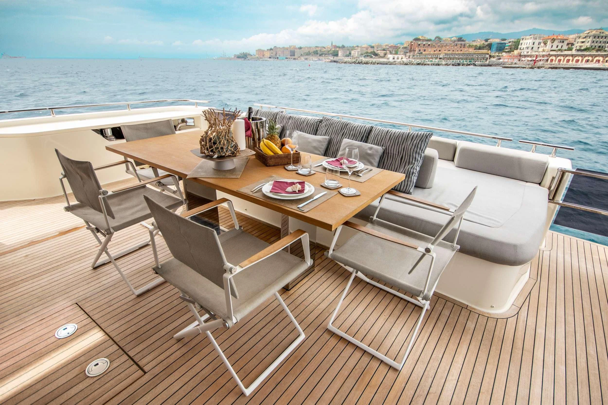 a table and chairs on a boat aboard E3 Yacht for Sale