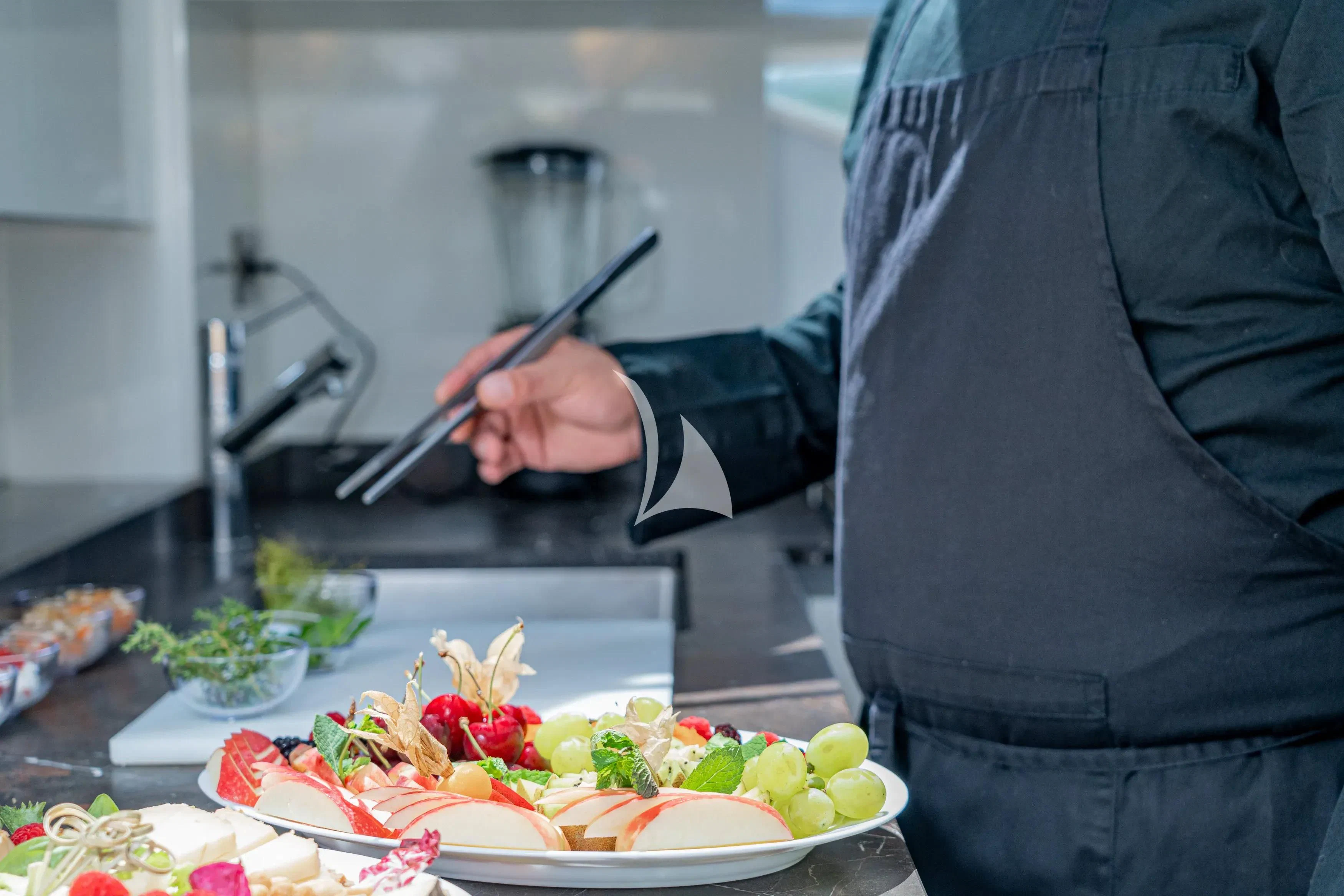 a person cutting a cake aboard E3 Yacht for Sale