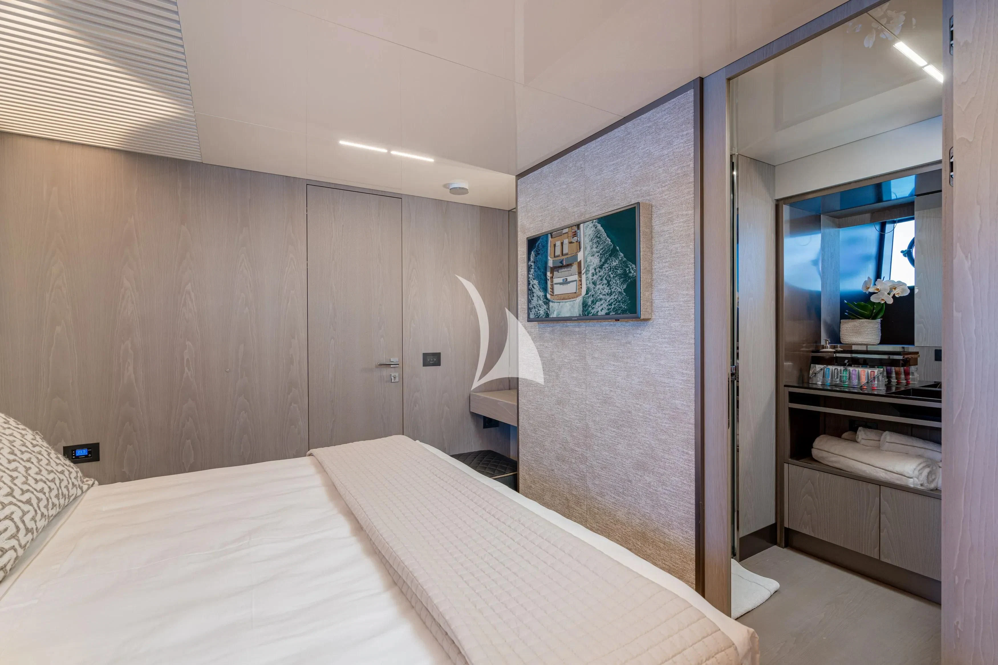 a bedroom with a bed and a mirror aboard E3 Yacht for Sale
