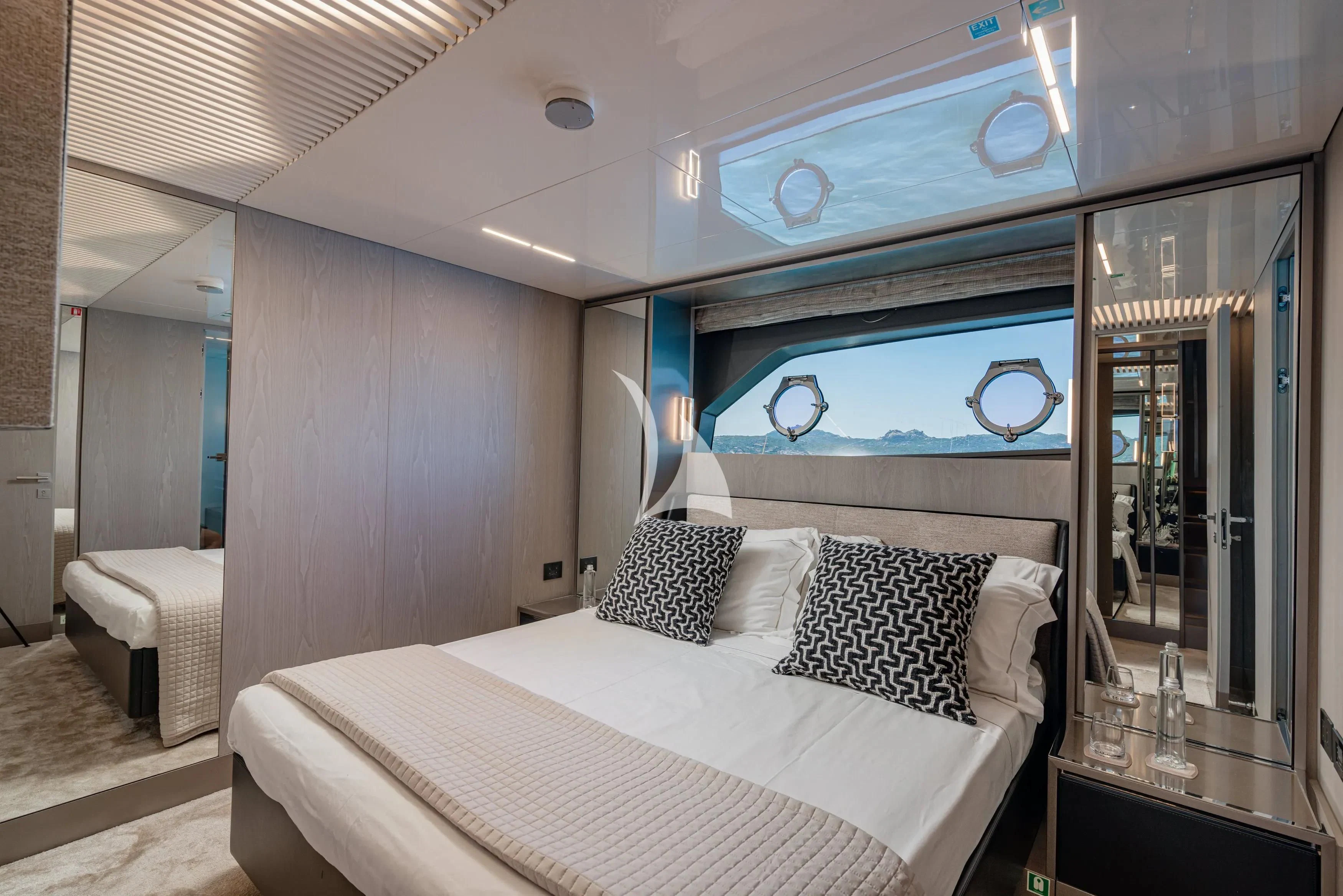 a bedroom with a large mirror aboard E3 Yacht for Sale