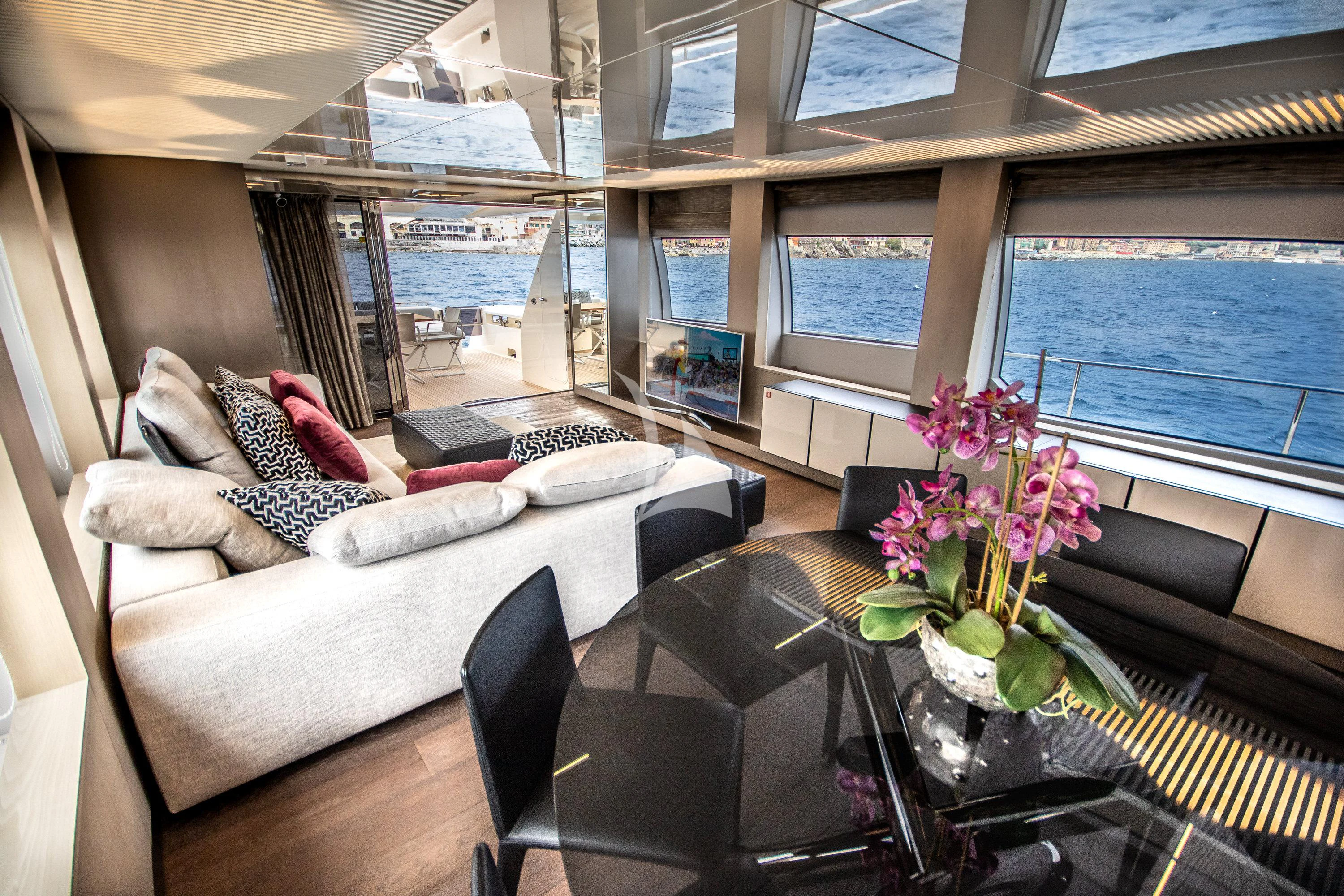 a living room with a large window aboard E3 Yacht for Sale