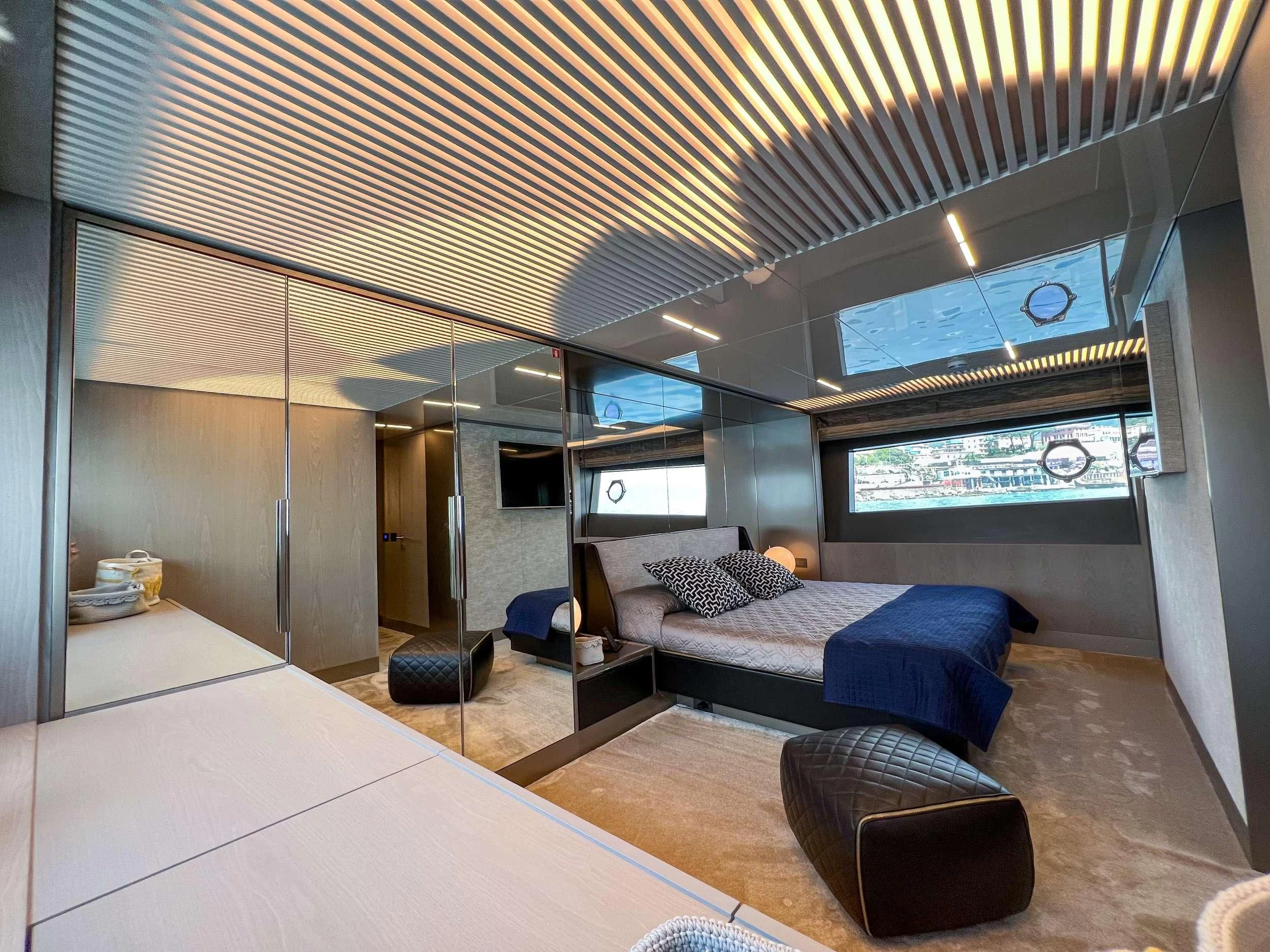 a room with a bed and a couch aboard E3 Yacht for Sale