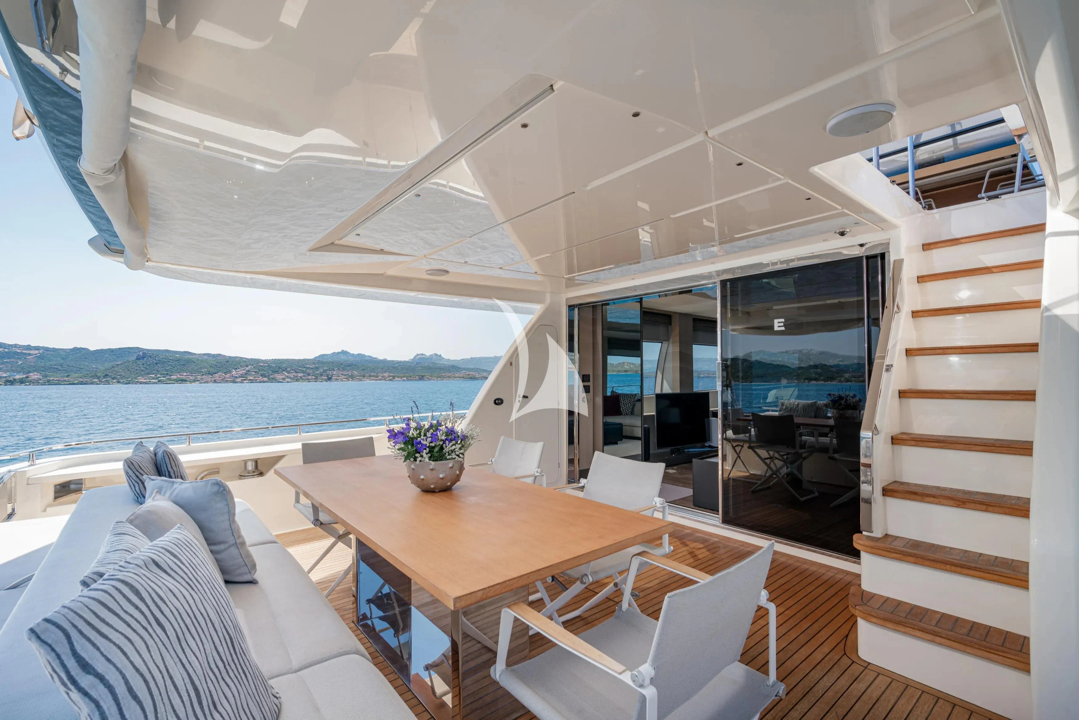 a room with a table and chairs aboard E3 Yacht for Sale