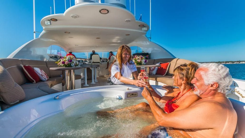 a group of people sitting on a boat aboard CEDAR ISLAND Yacht for Sale