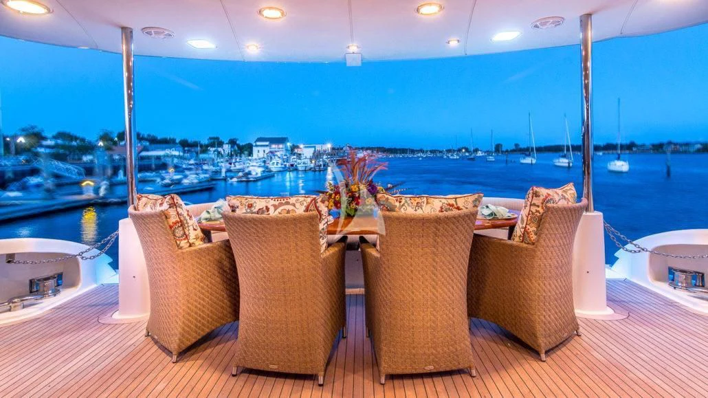 a table with chairs on it aboard CEDAR ISLAND Yacht for Sale