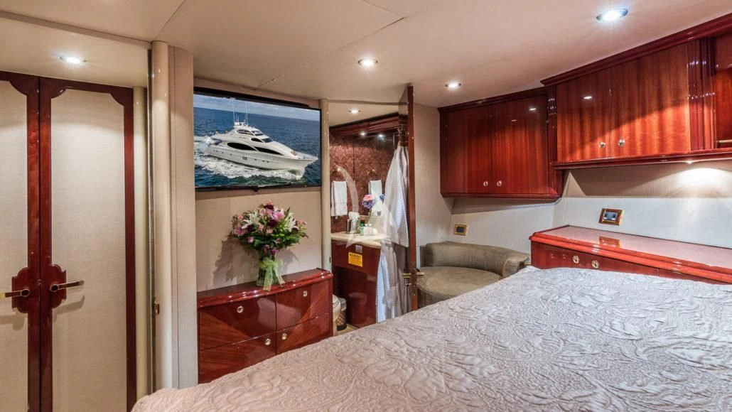 a bedroom with a bed and a television aboard CEDAR ISLAND Yacht for Sale